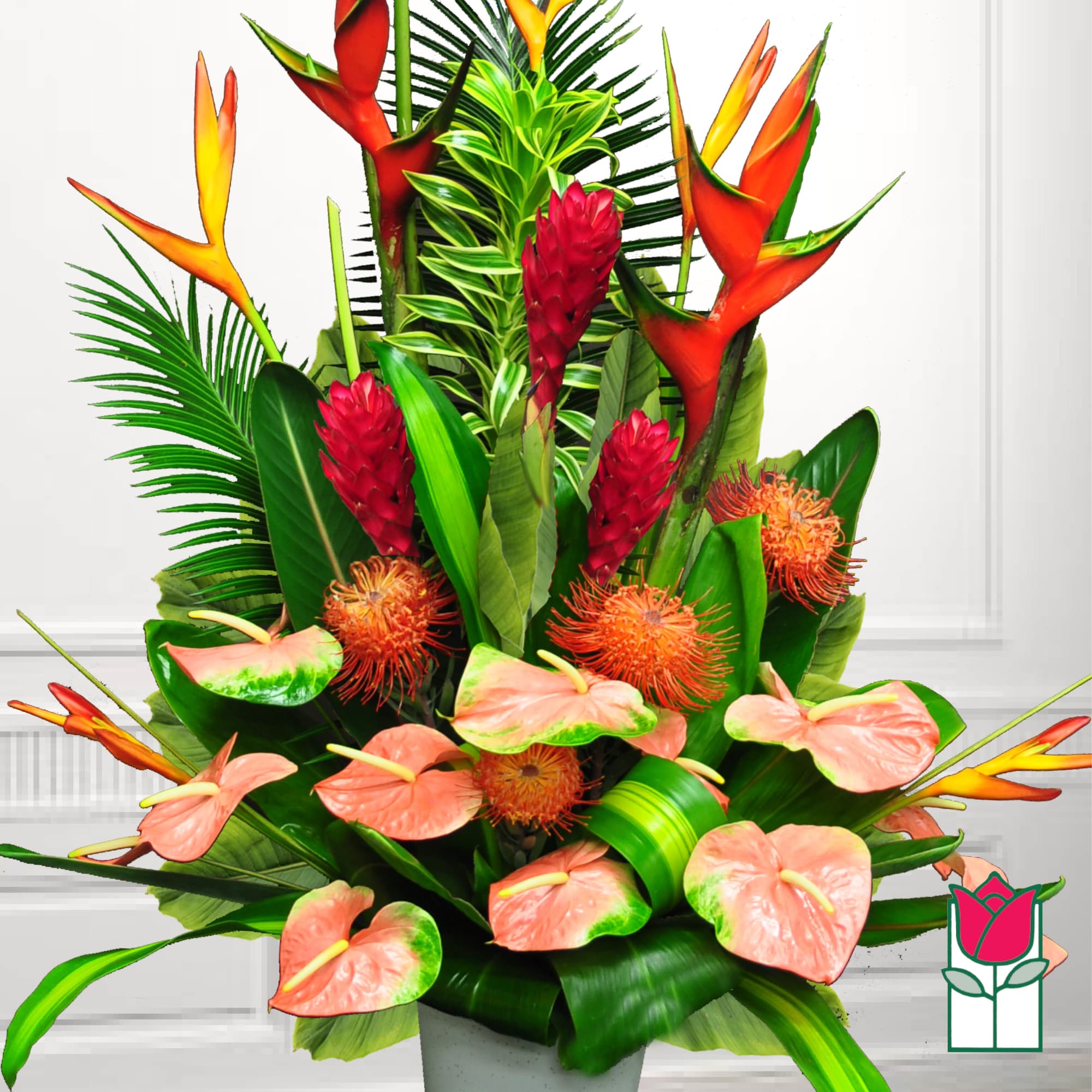 Tropical arrangement with pink anthuriums and orange heliconia in a vase