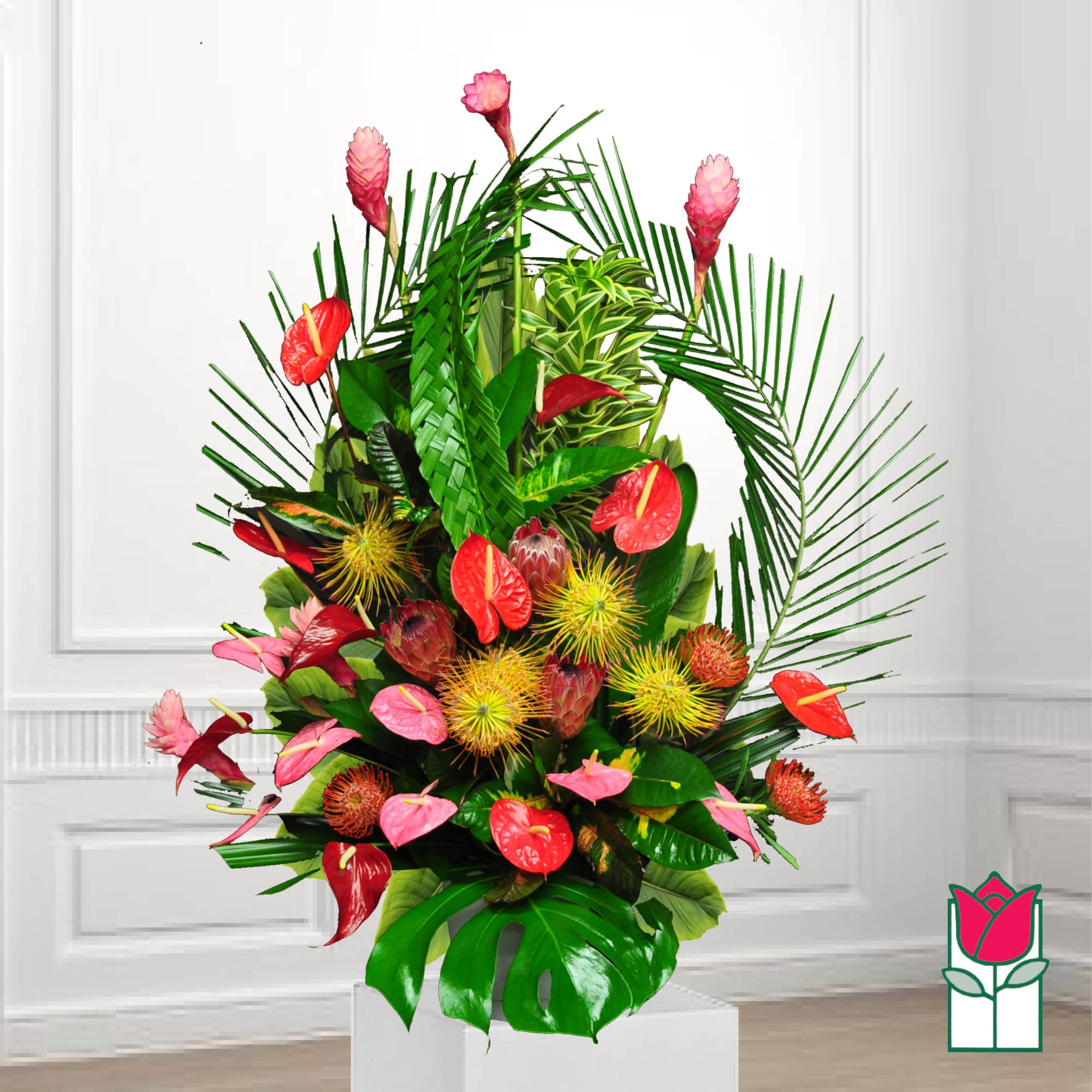 Tropical arrangement with red anthuriums and pink ginger flowers