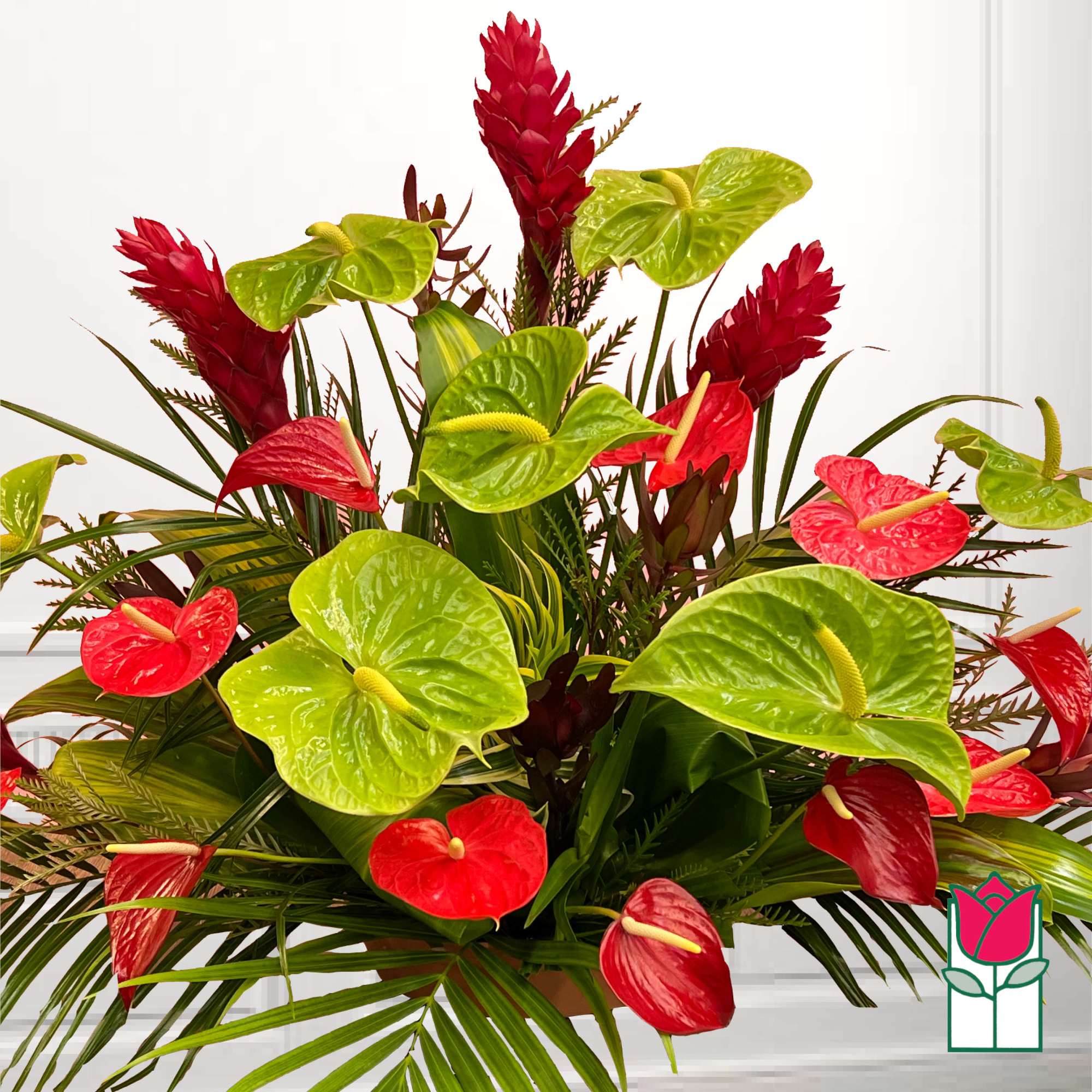 Tropical arrangement with red and green anthuriums and red ginger flowers