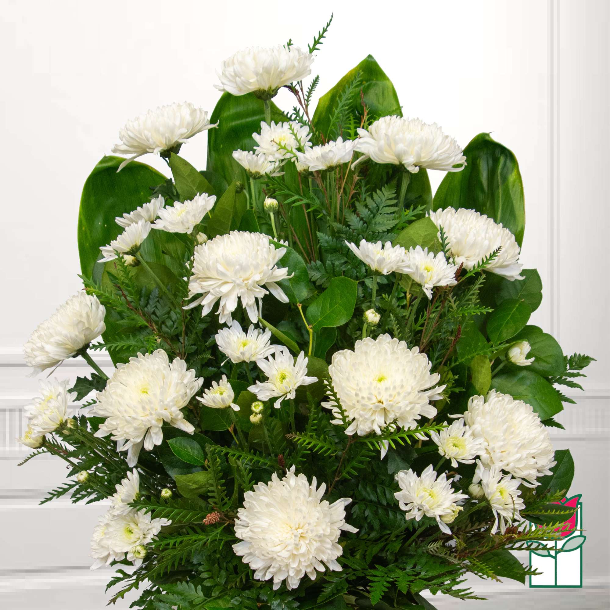 White chrysanthemum bouquet with lush green foliage