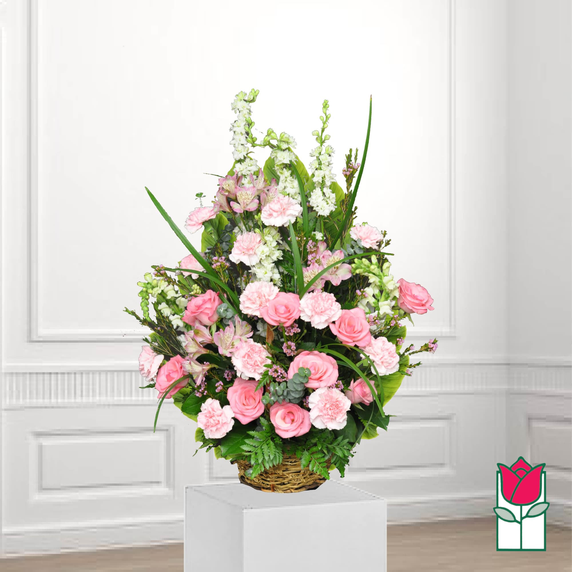 Pink roses and carnations in a wicker basket arrangement