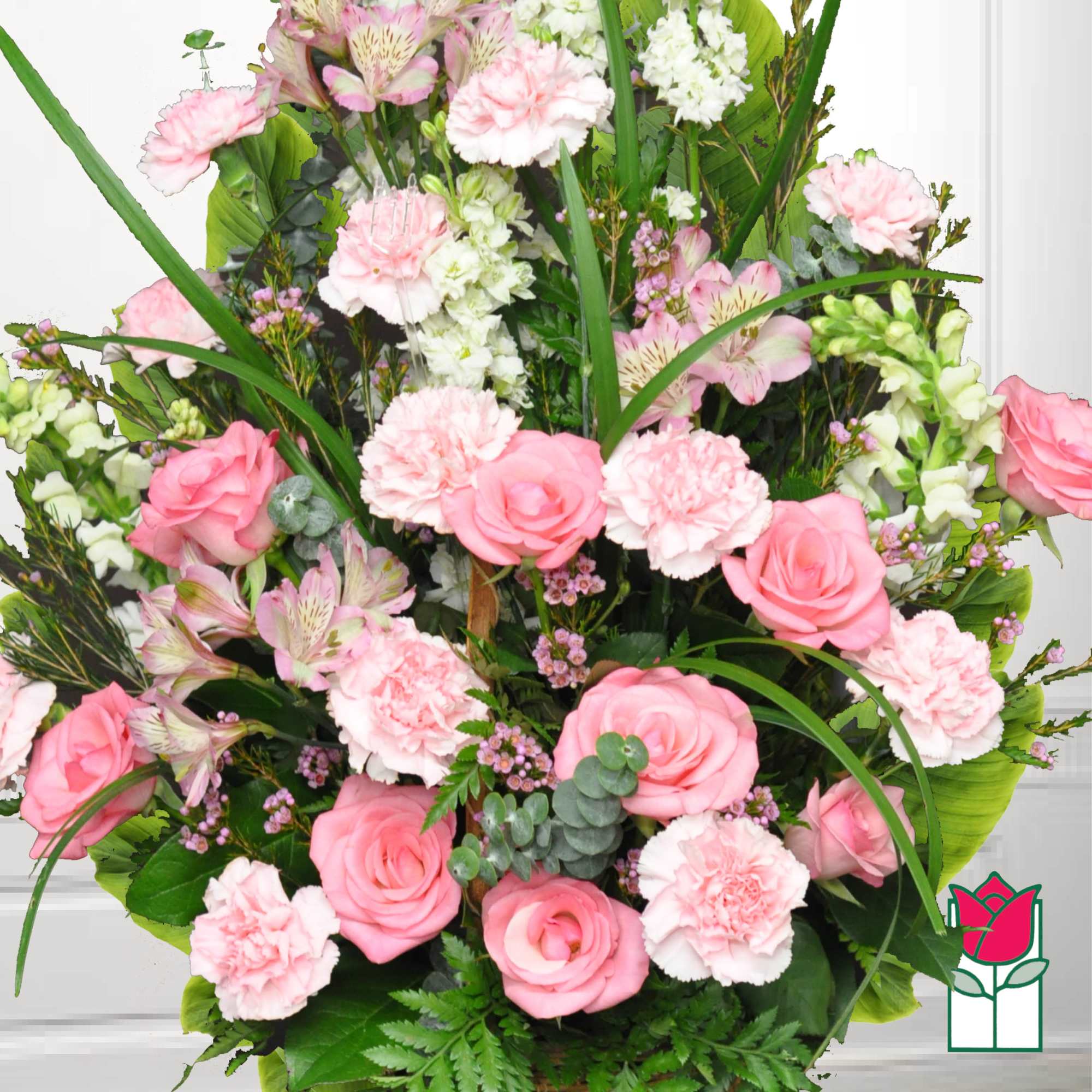 Pink roses and carnations arranged with white blooms in a lush bouquet.