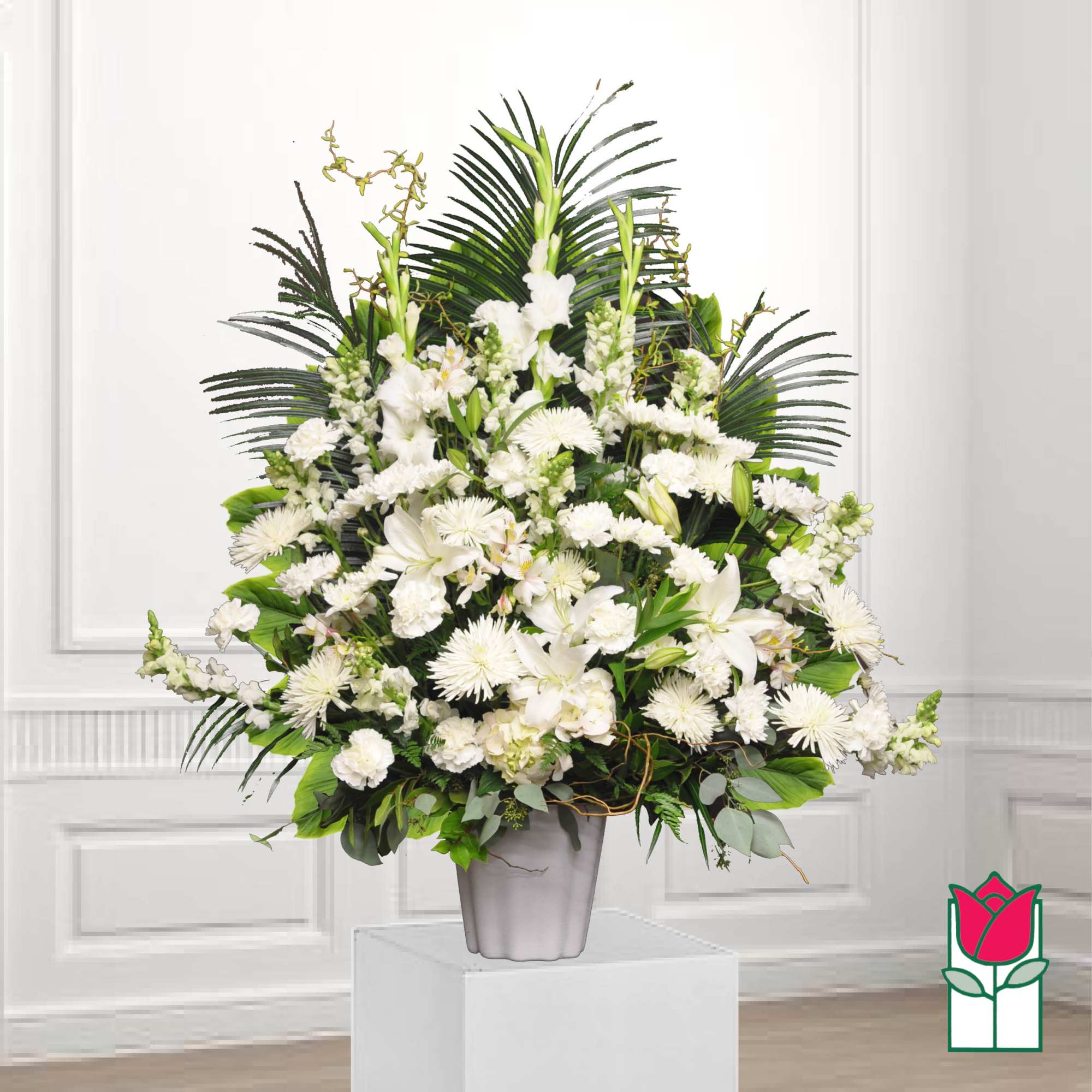 White floral arrangement in a gray vase with palm fronds
