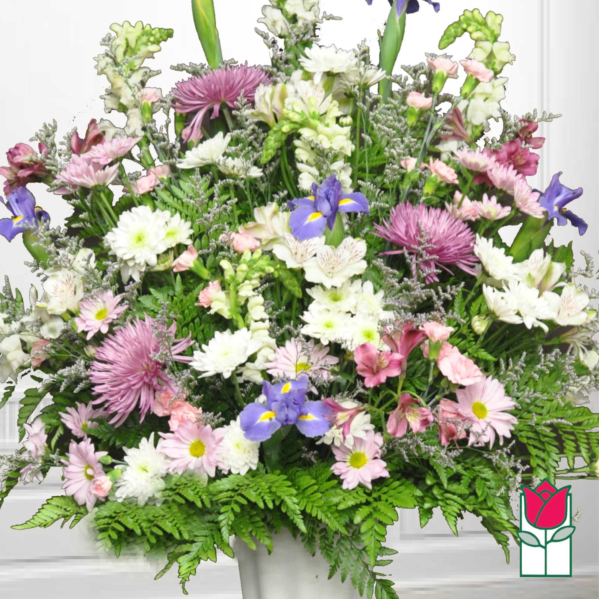 Large mixed bouquet of pink, white, and purple flowers in a white vase