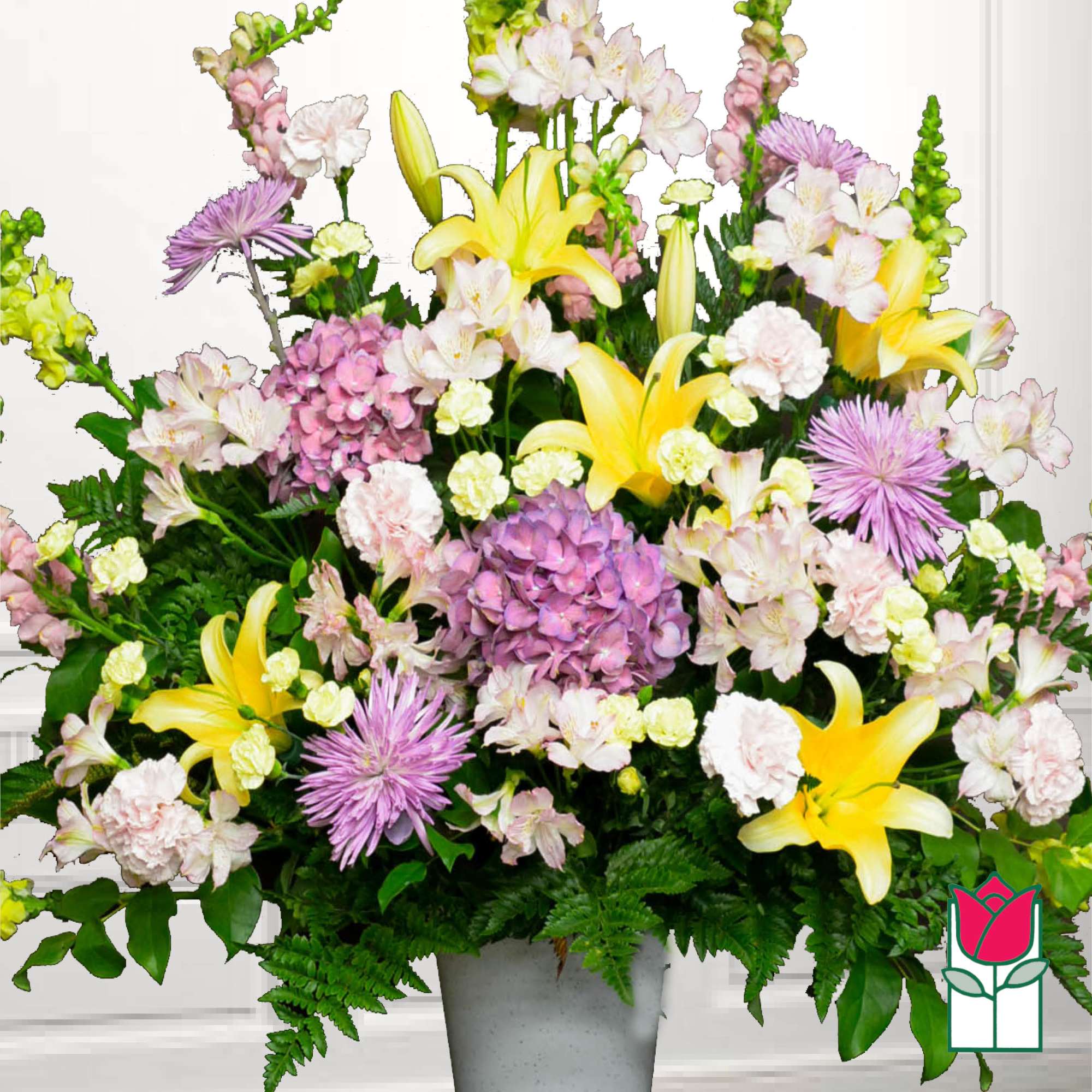 Large mixed bouquet with yellow lilies, pink hydrangeas, and lavender chrysanthemums in a vase