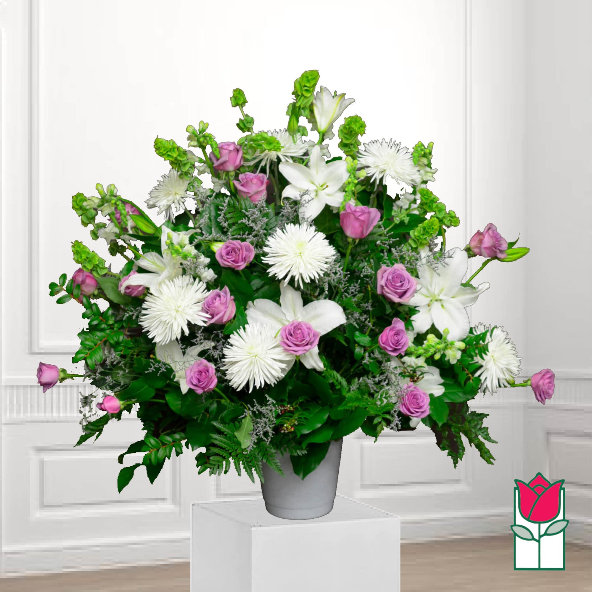 Bouquet of white lilies, pink roses, and white spider mums in a gray vase