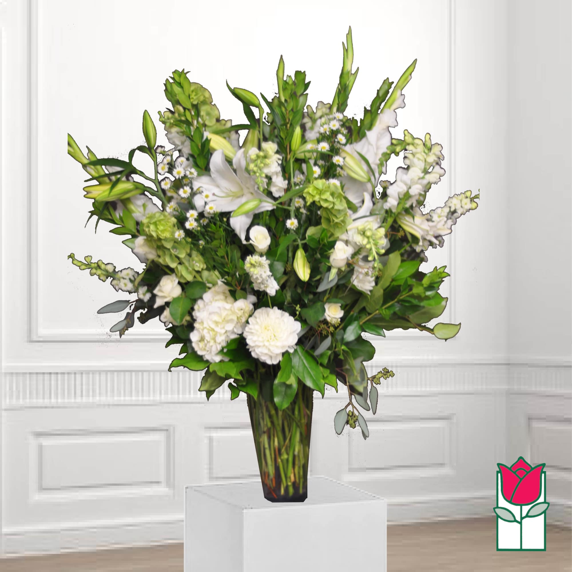Tall white floral arrangement in a clear glass vase