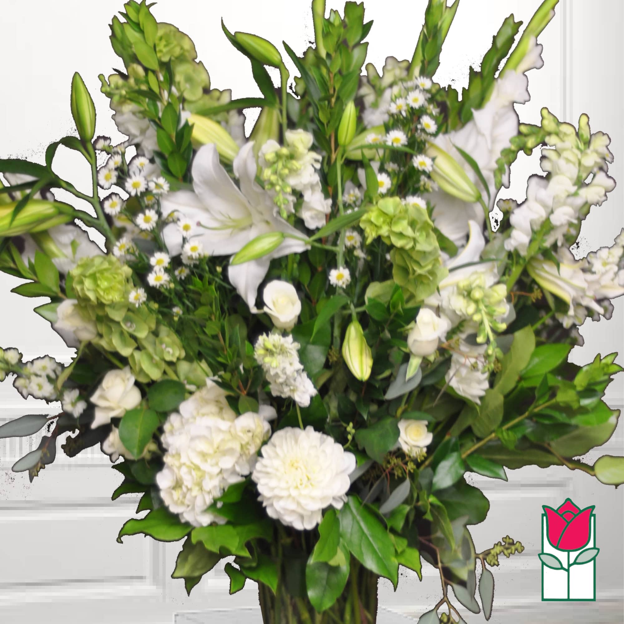 White lilies and mixed white blooms in a tall arrangement