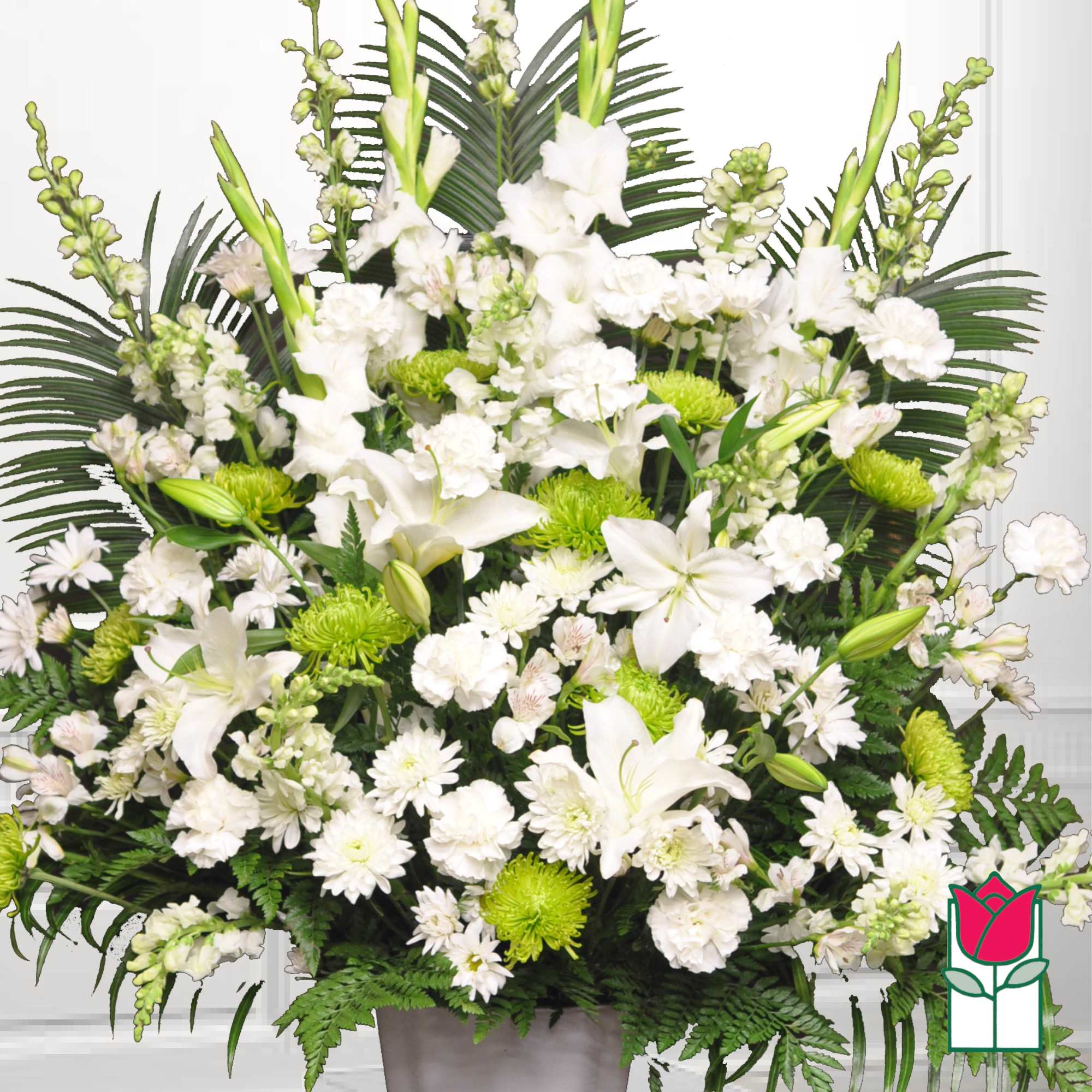 White lilies and chrysanthemums arranged in a vase with green accents
