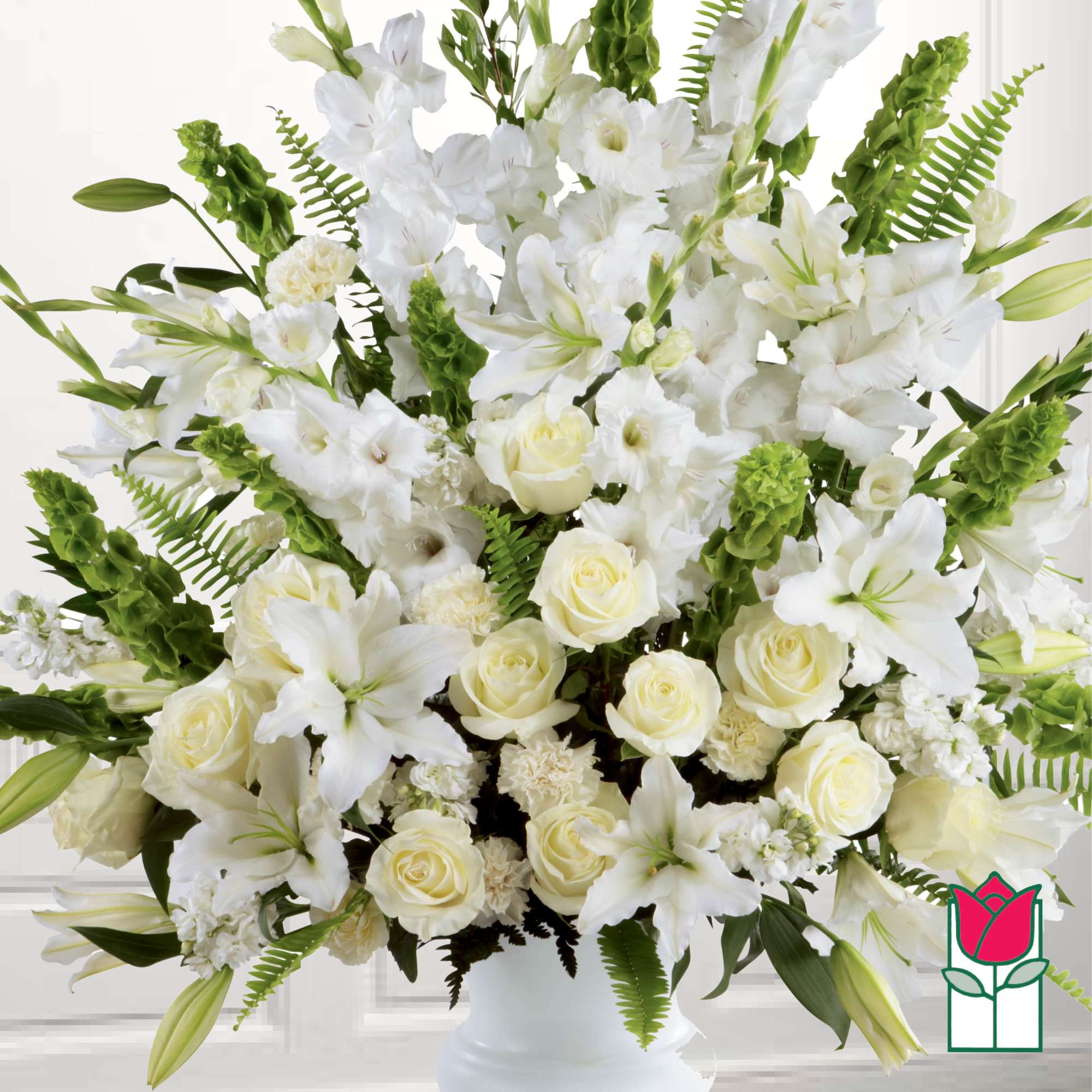 White lilies and roses arranged in a white vase