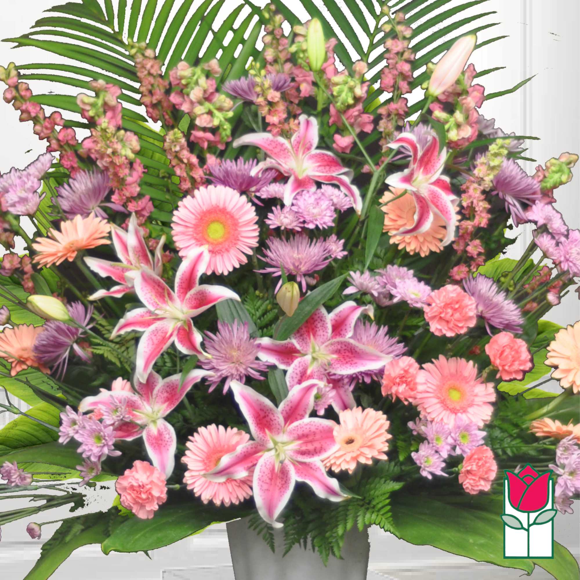 Pink and lavender flowers arranged in a white vase