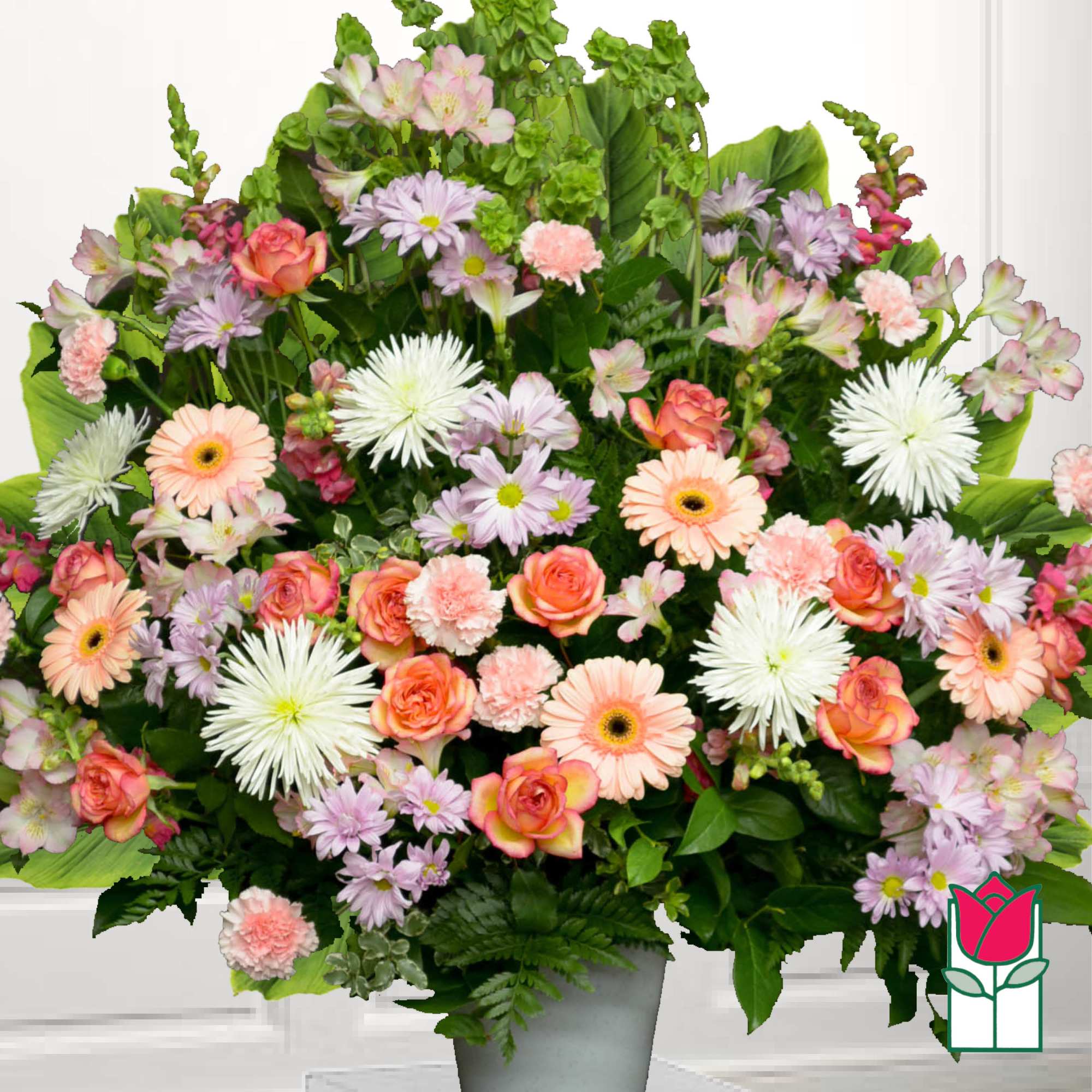 Large mixed bouquet of pastel flowers in a gray vase