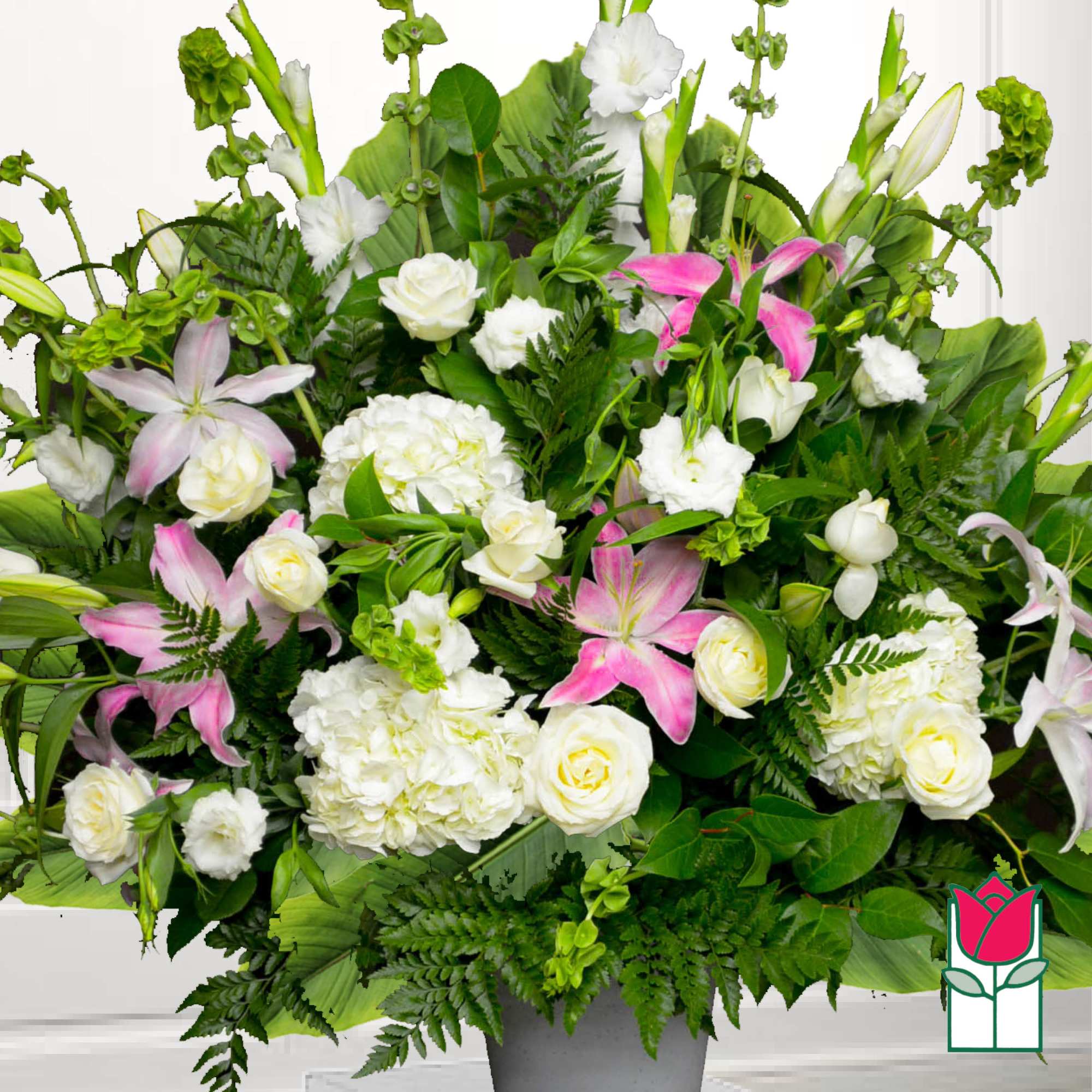White and pink floral arrangement in a gray vase