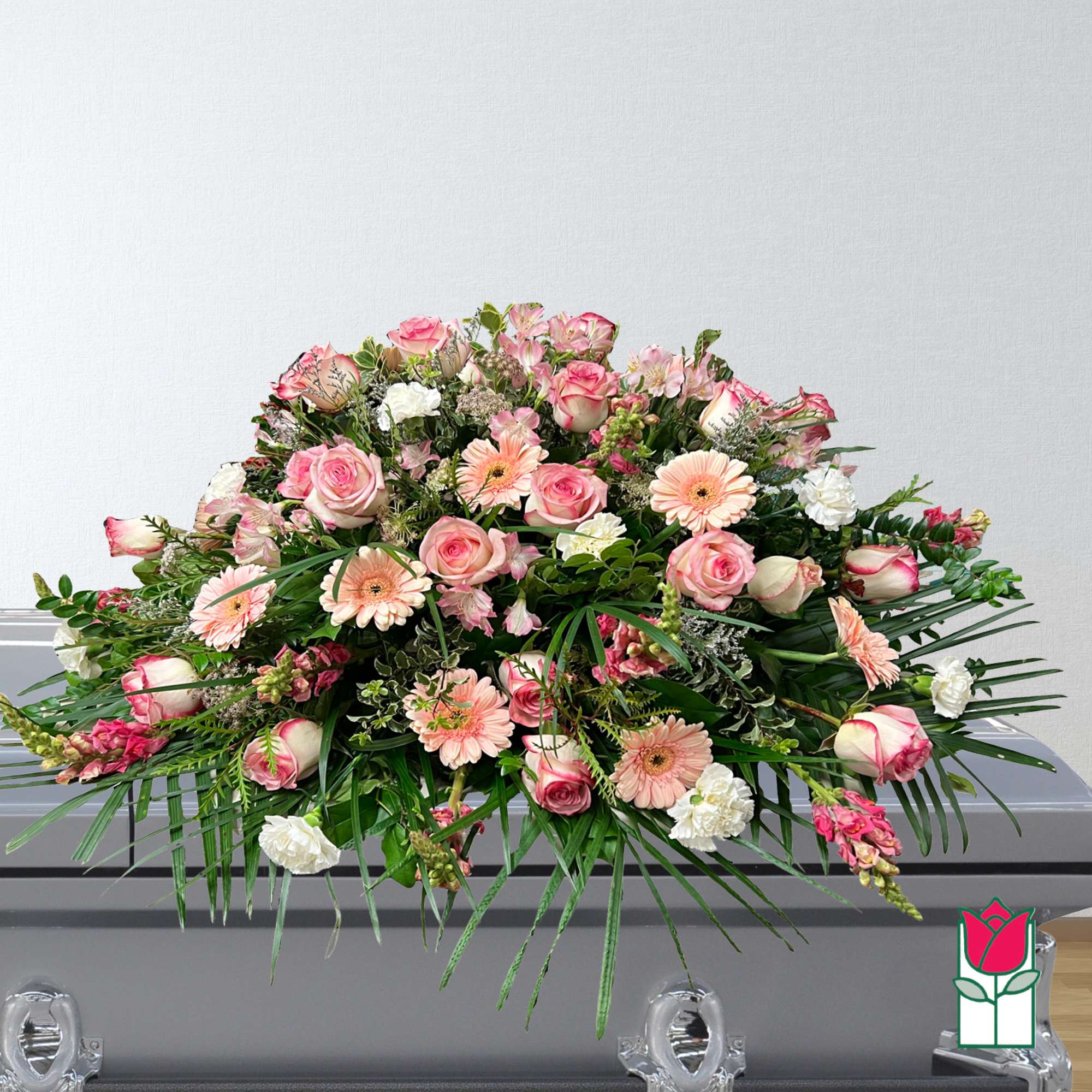 Large pink and white floral casket spray with roses and gerbera daisies