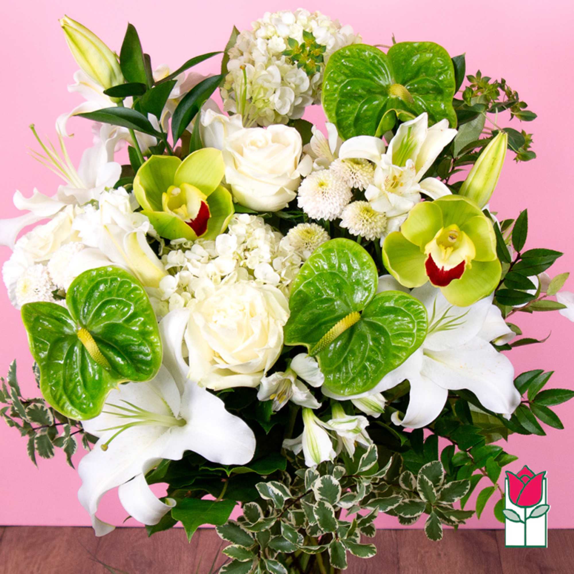 White lilies, roses, and green orchids in a mixed bouquet