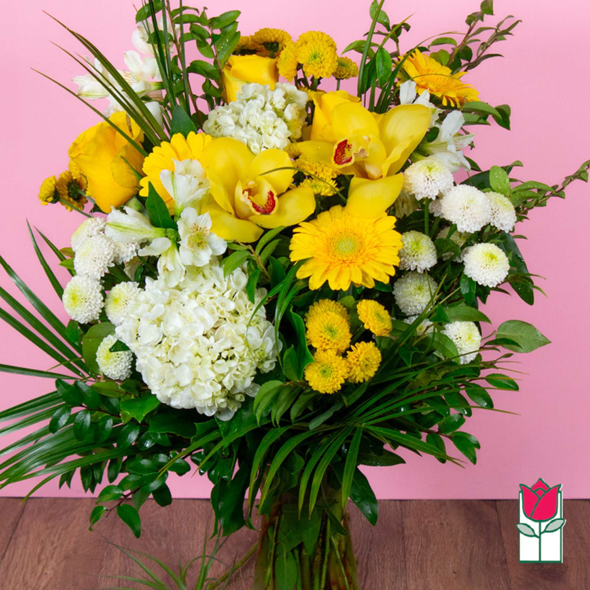 Yellow and white mixed flower arrangement with orchids and daisies