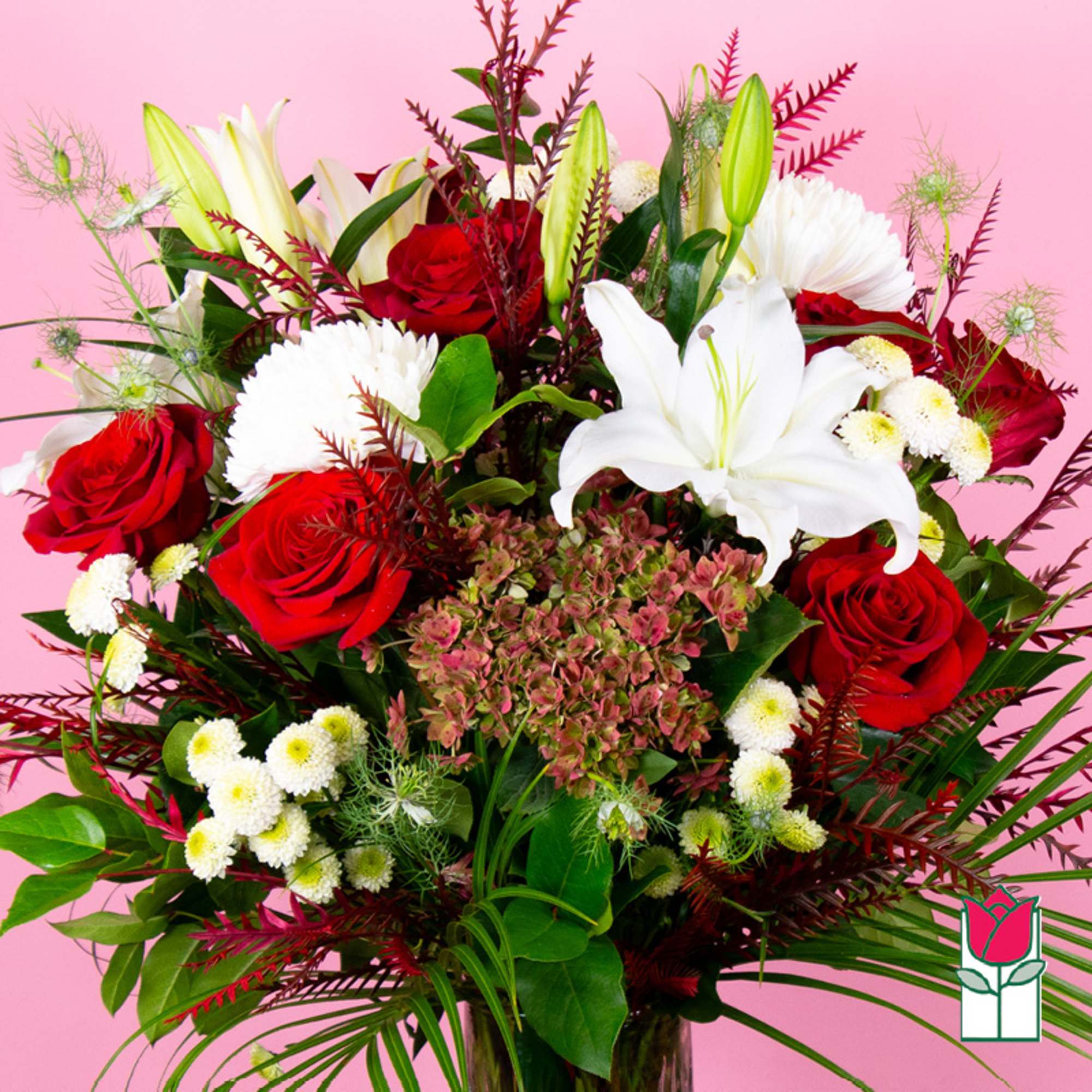Bouquet of red roses and white lilies with white mums on a pink background