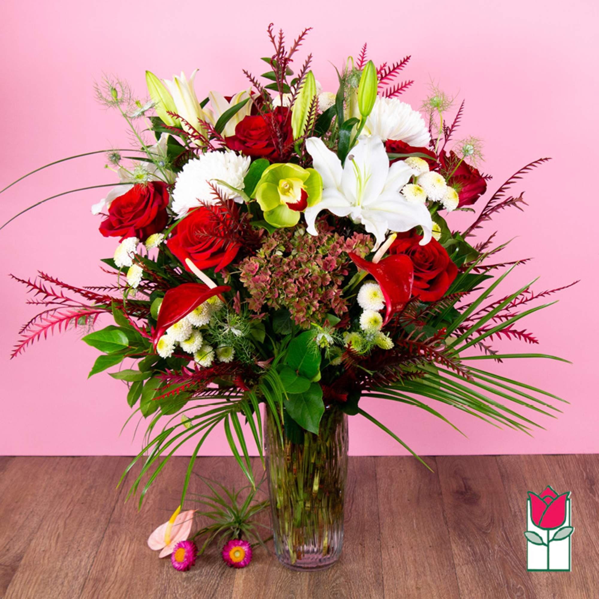 Bouquet of red roses and white lilies in a glass vase