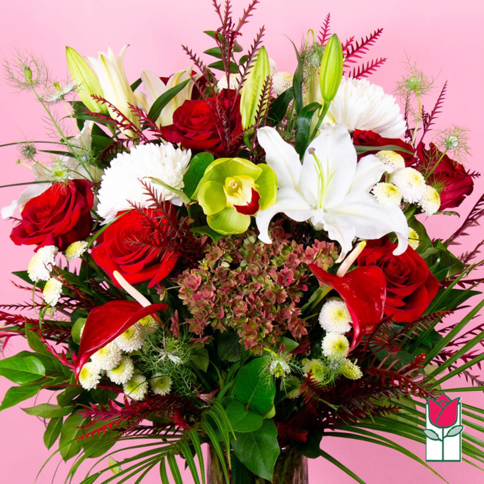 Bouquet of red roses, white lilies, and white chrysanthemums on a pink background