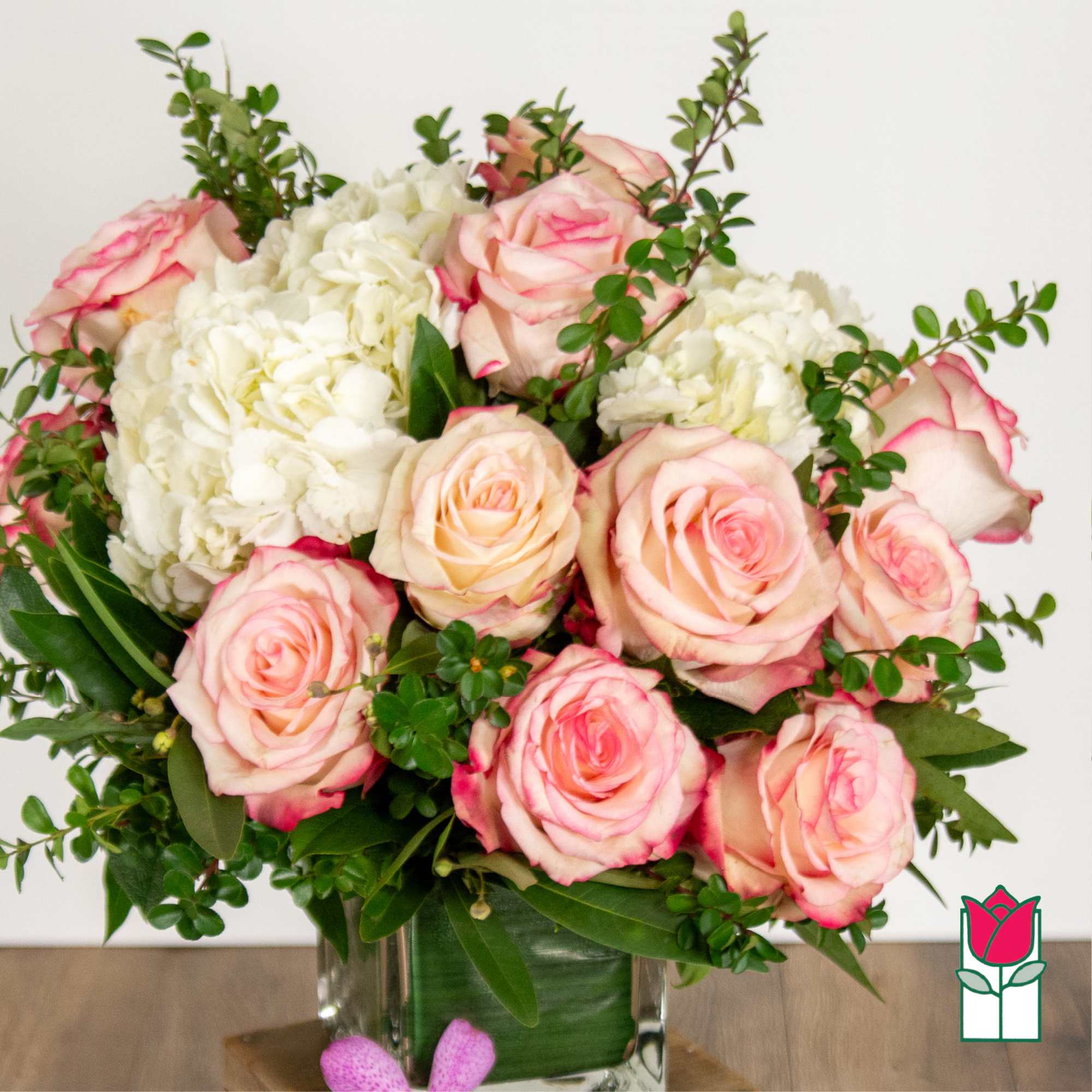 Pink roses and white hydrangeas in a glass vase