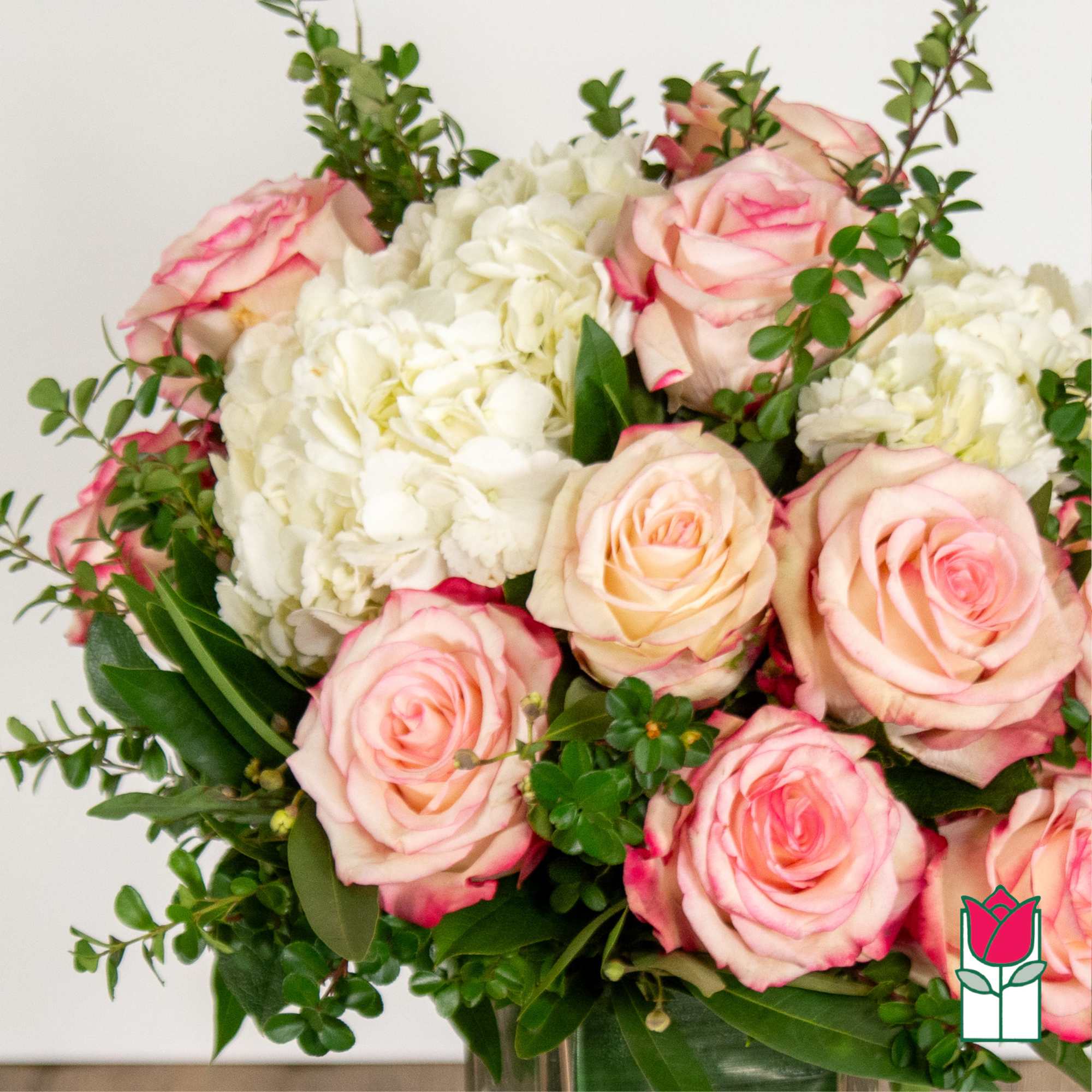 Bouquet of pink roses and white hydrangeas with greenery