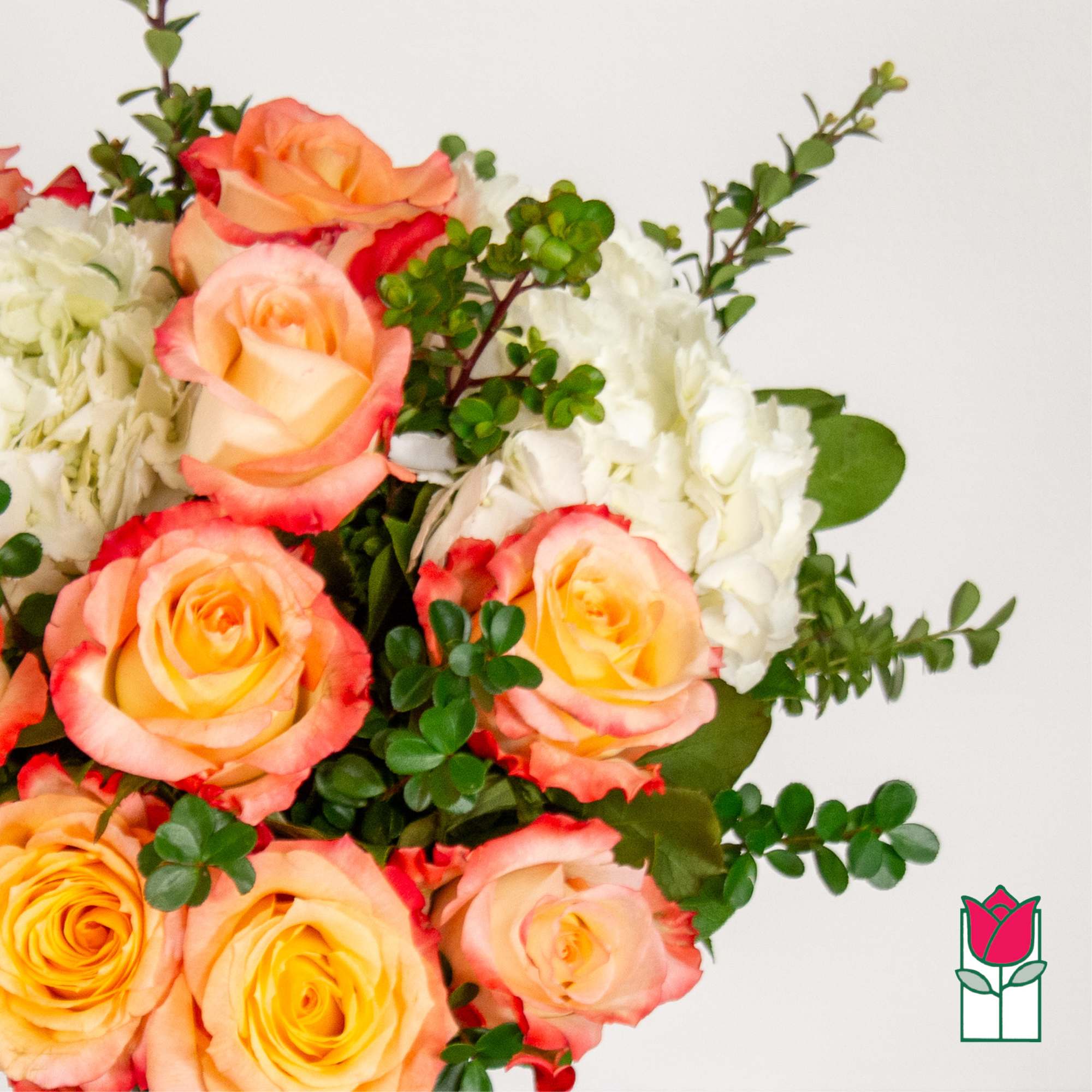 Bouquet of peach and pink roses with white hydrangeas