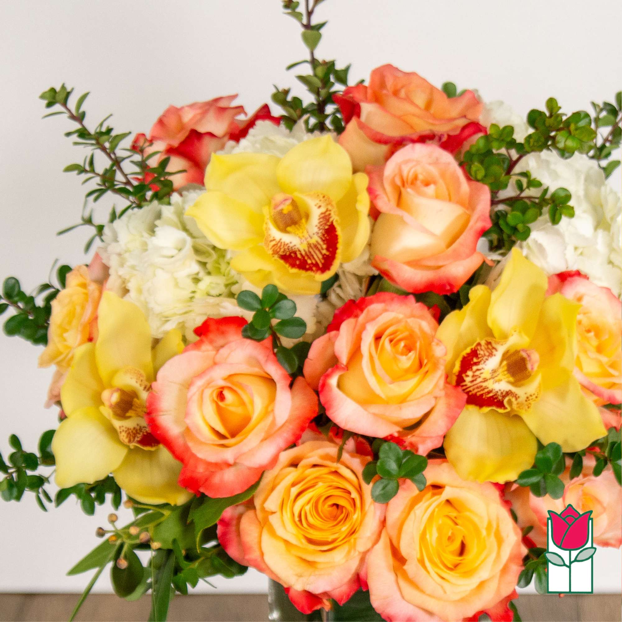 Bouquet of peach roses and yellow orchids with white filler flowers