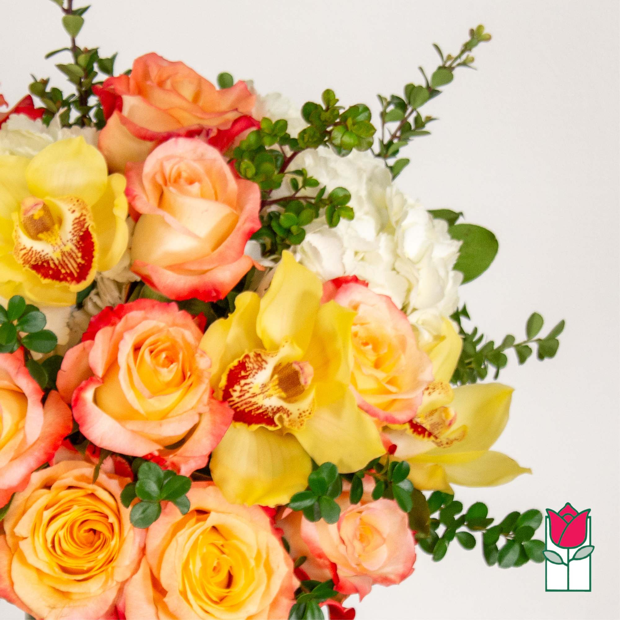 Bouquet of peach and yellow roses with yellow orchids and white hydrangea