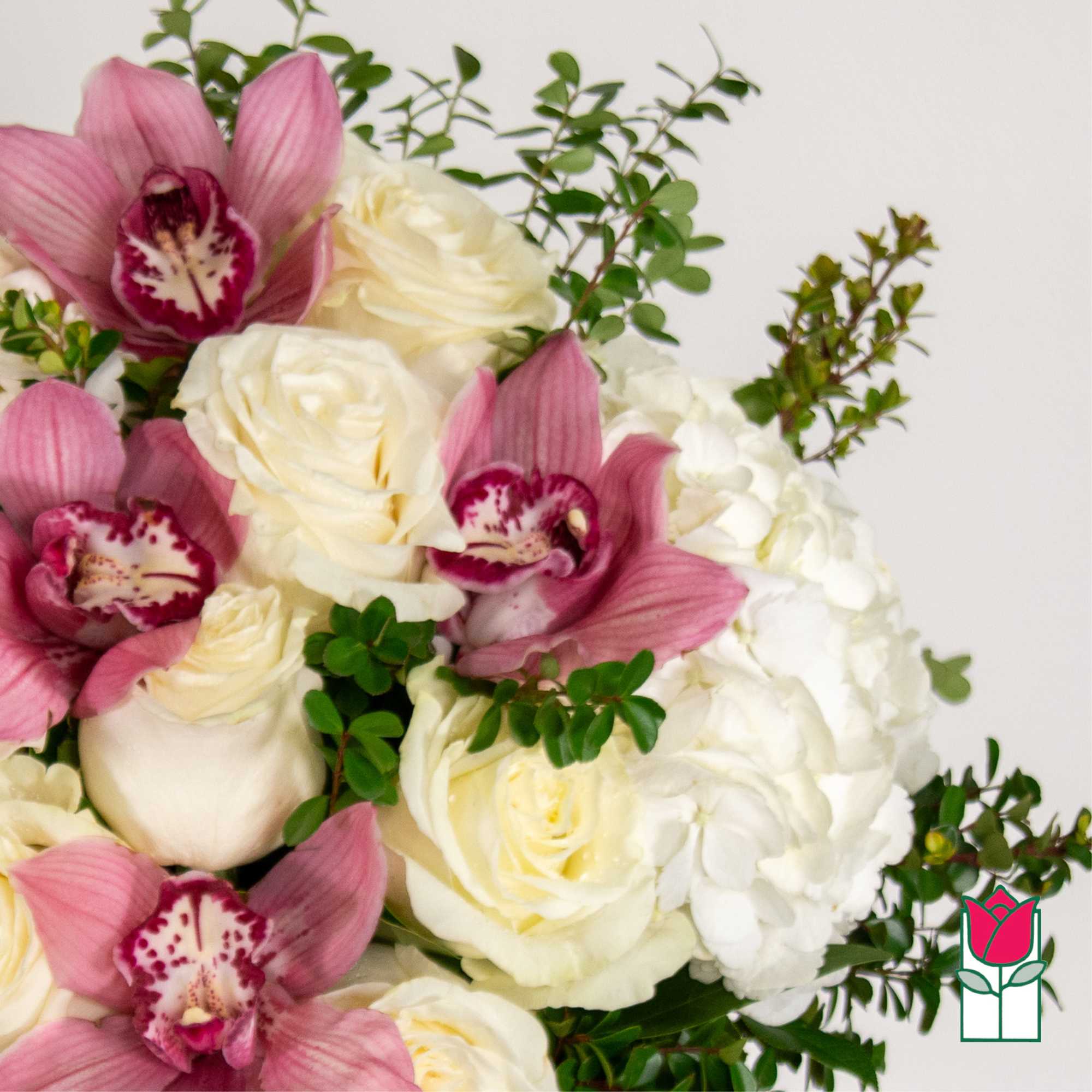 Pink orchids with white roses and hydrangea in a bouquet