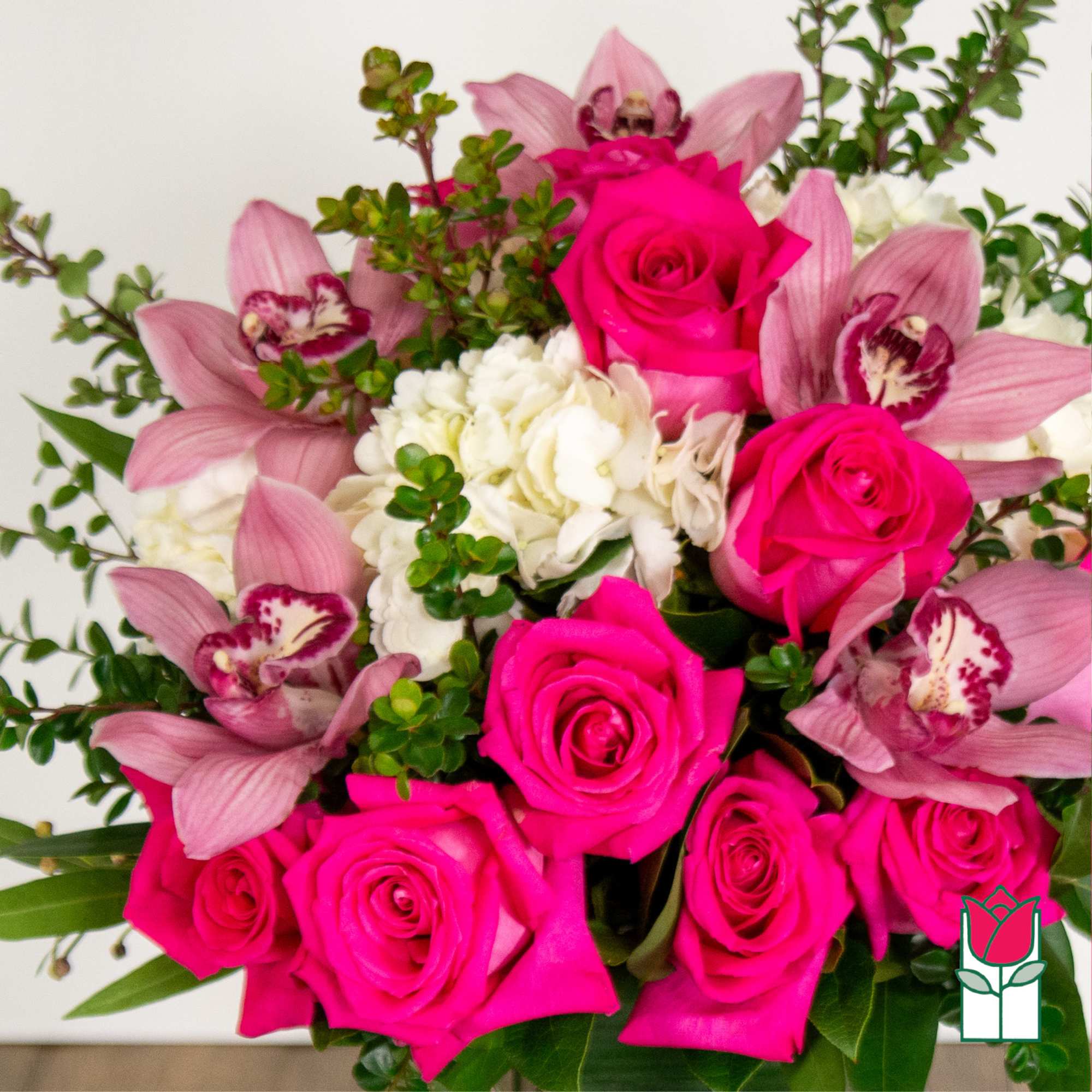 Bouquet of hot pink roses and pink orchids with white flowers