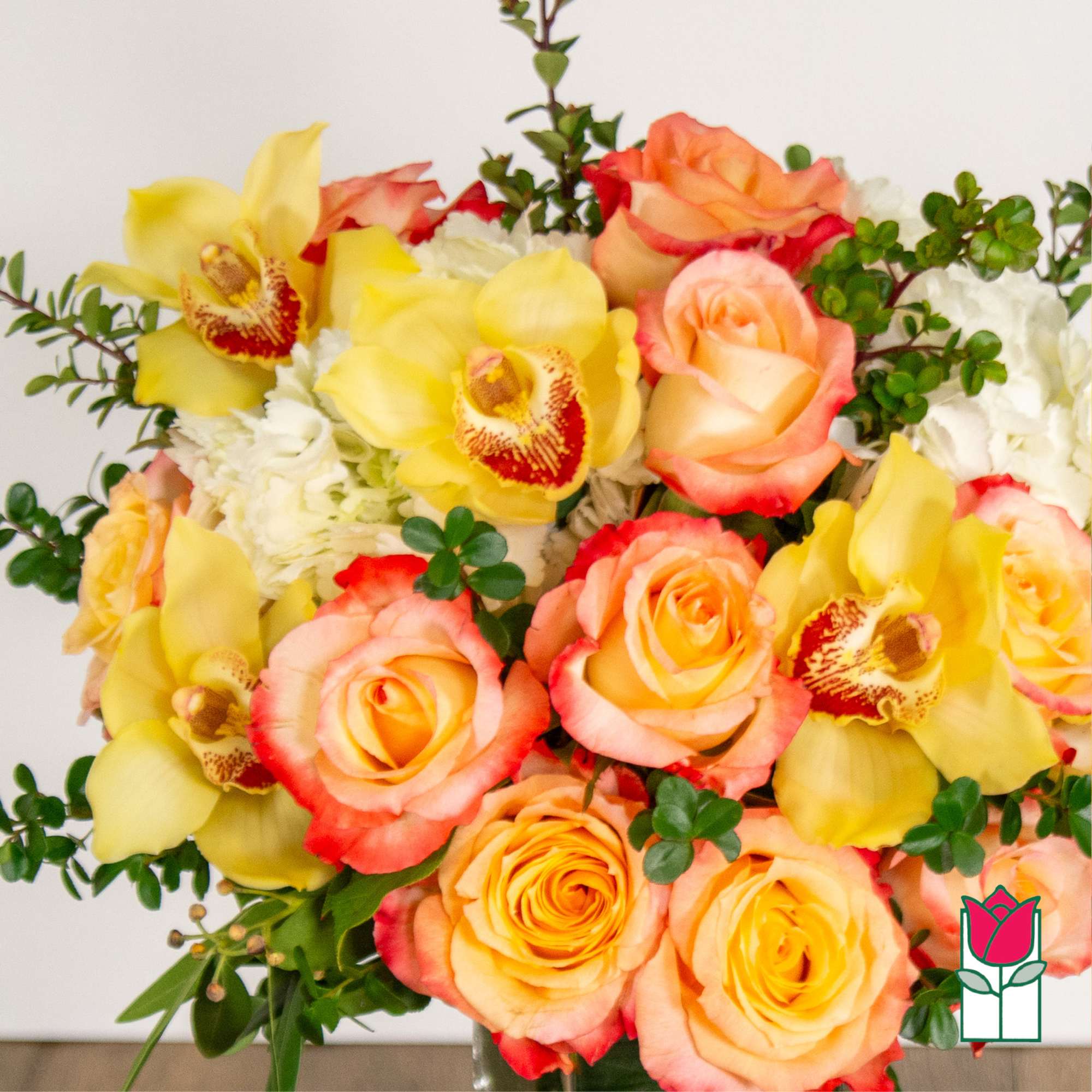Bouquet of peach roses and yellow orchids with white filler flowers