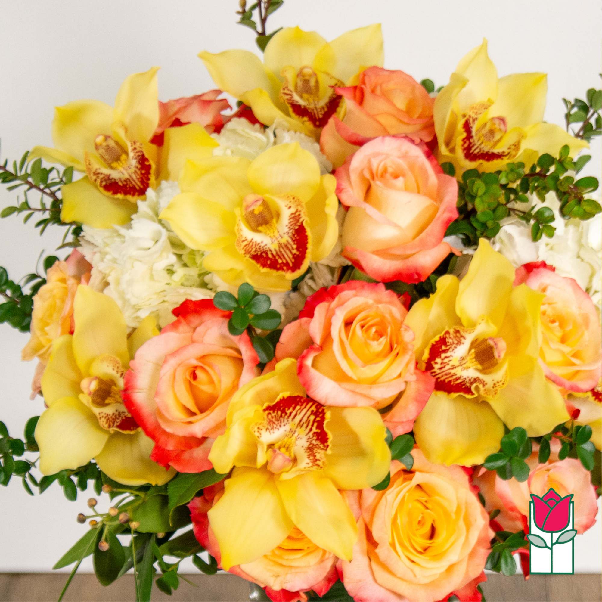 Bouquet of yellow orchids and peach roses with white filler flowers