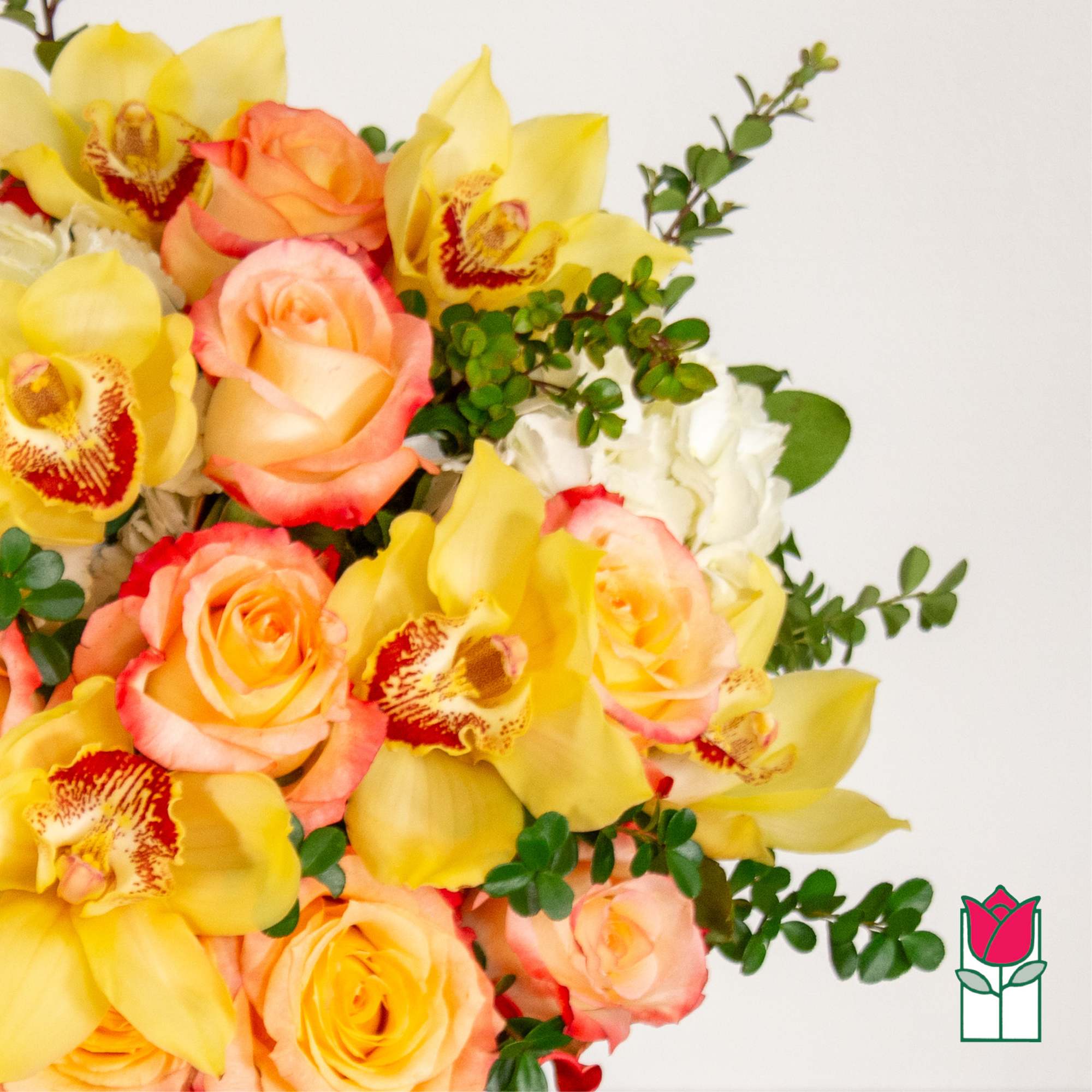 Bouquet of yellow orchids and peach roses with greenery