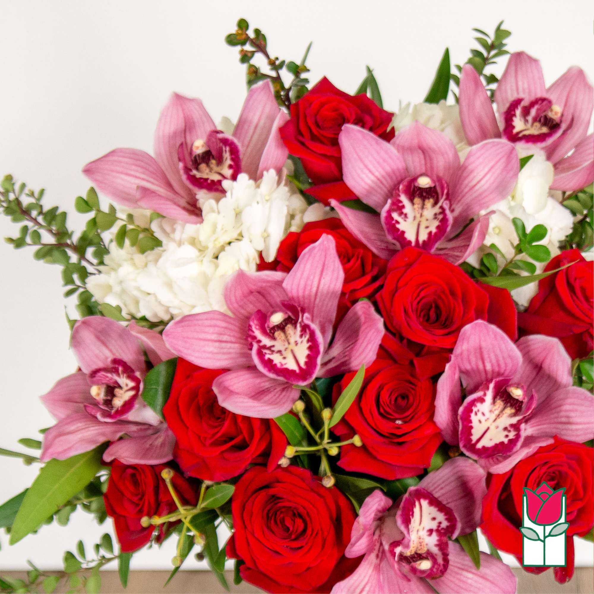 Bouquet of red roses and pink orchids with white filler flowers