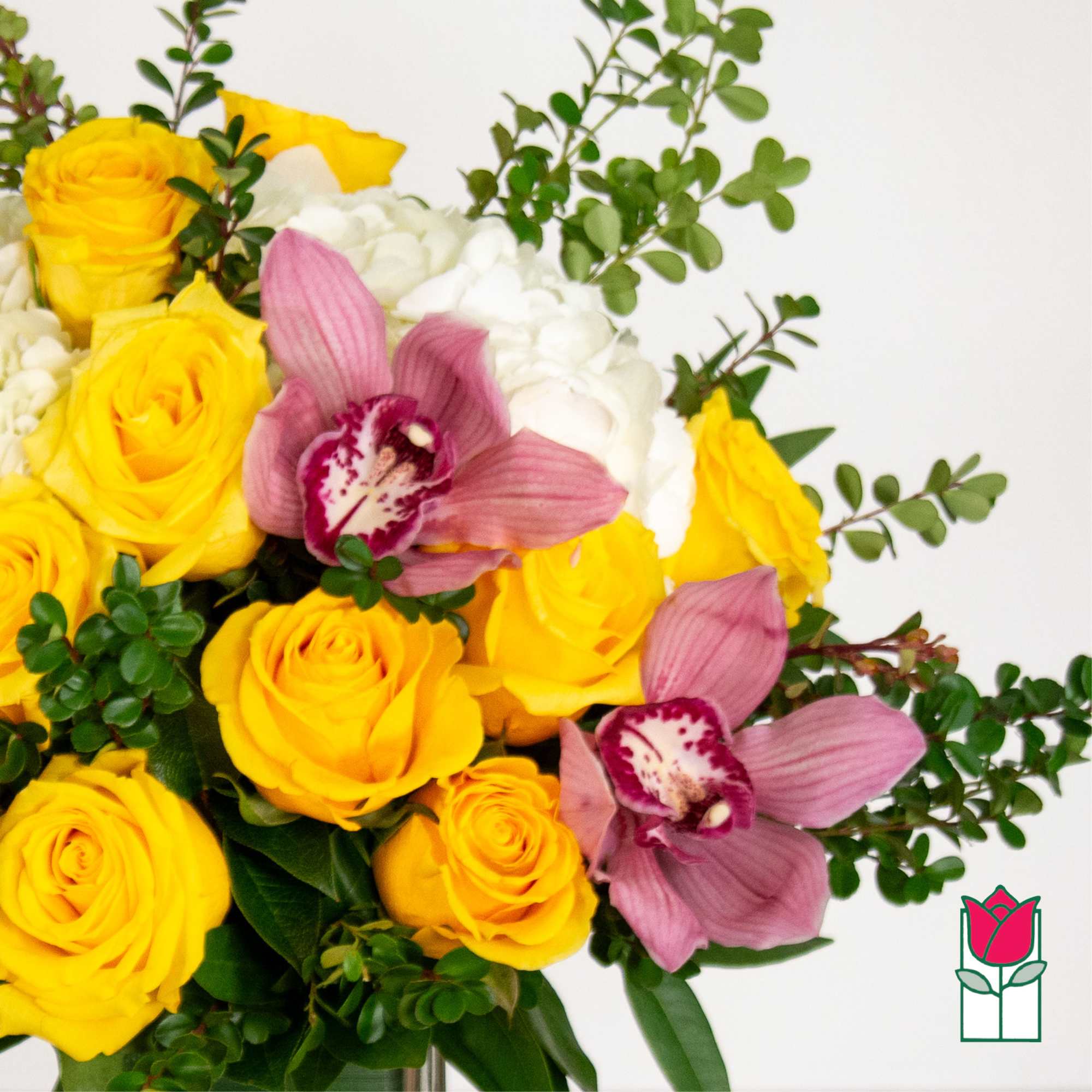Bouquet of yellow roses, pink orchids, and white blooms