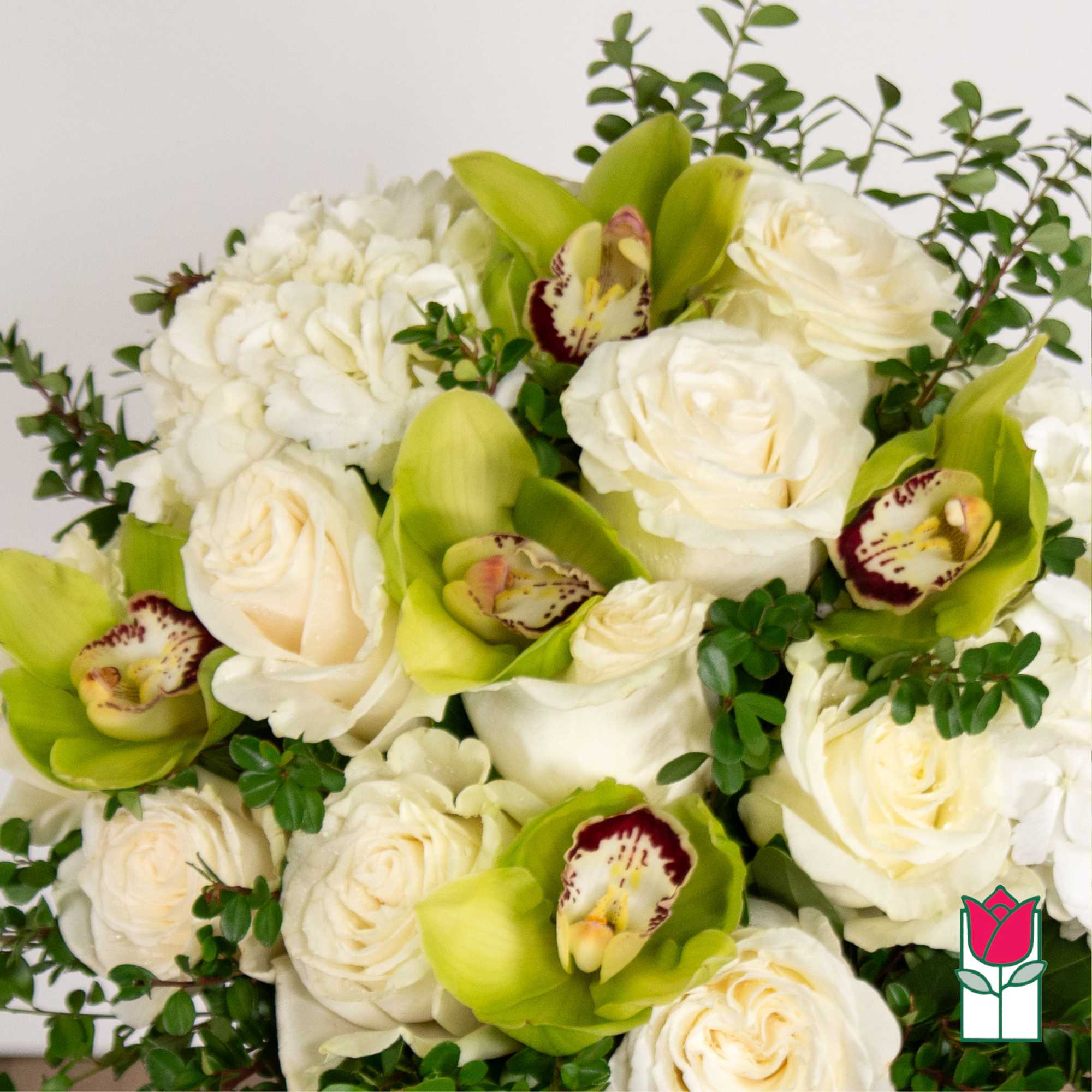 White roses and green orchids in a bouquet