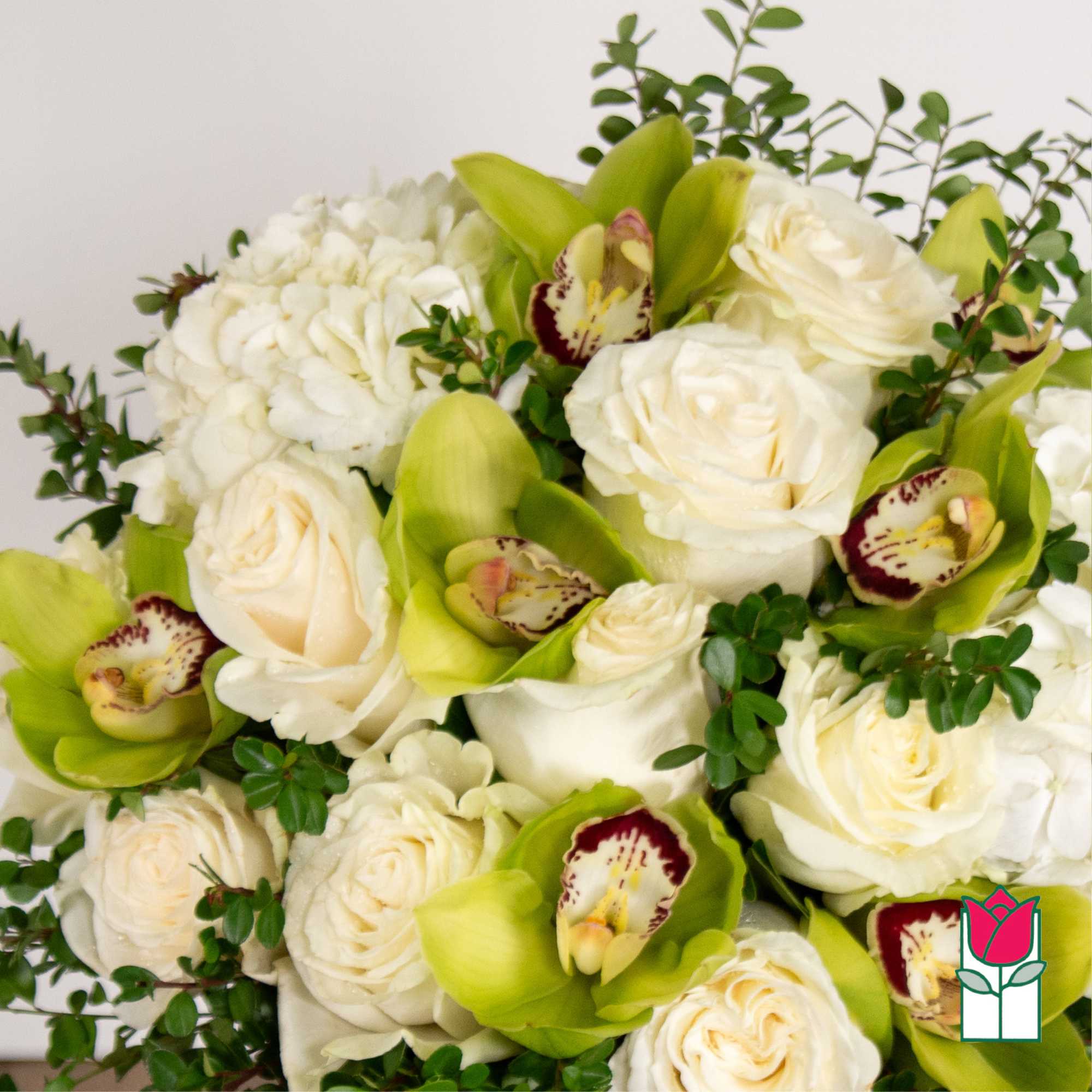 Bouquet of white roses and green orchids with small greenery
