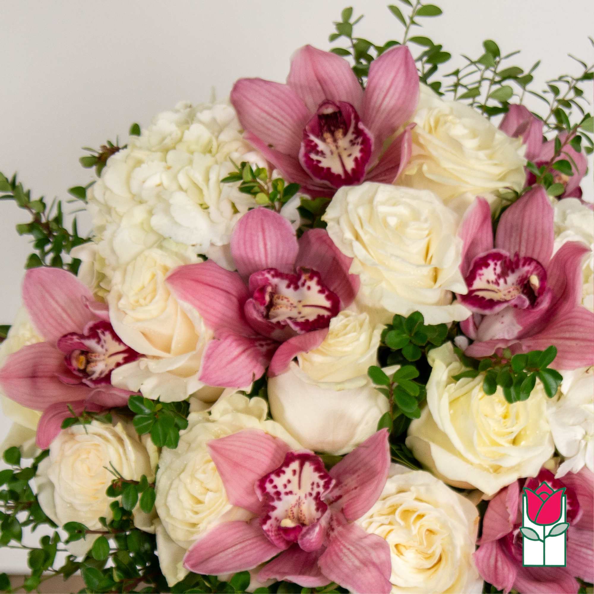 Bouquet of white roses and pink orchids with green filler