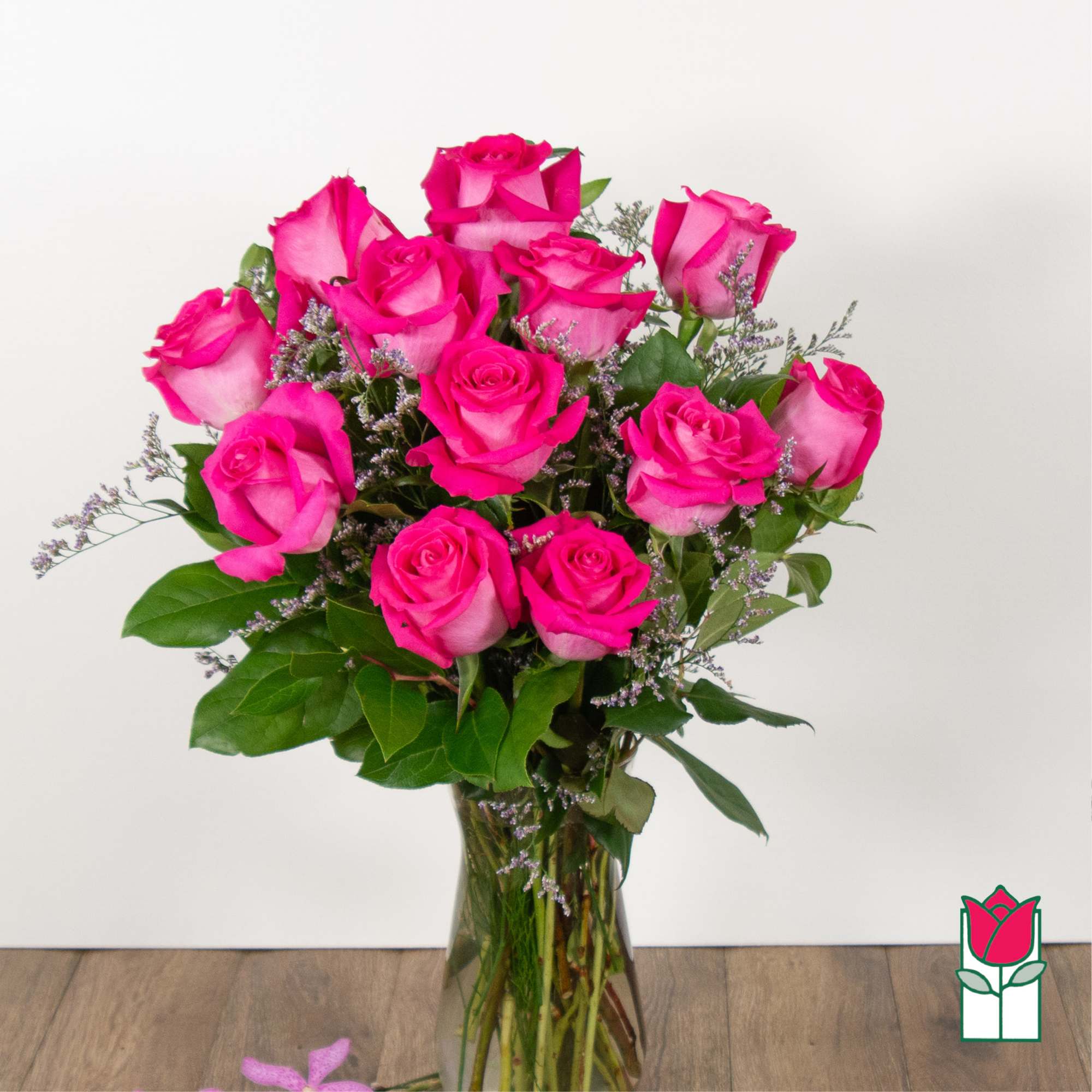 Bouquet of bright pink roses in a clear glass vase