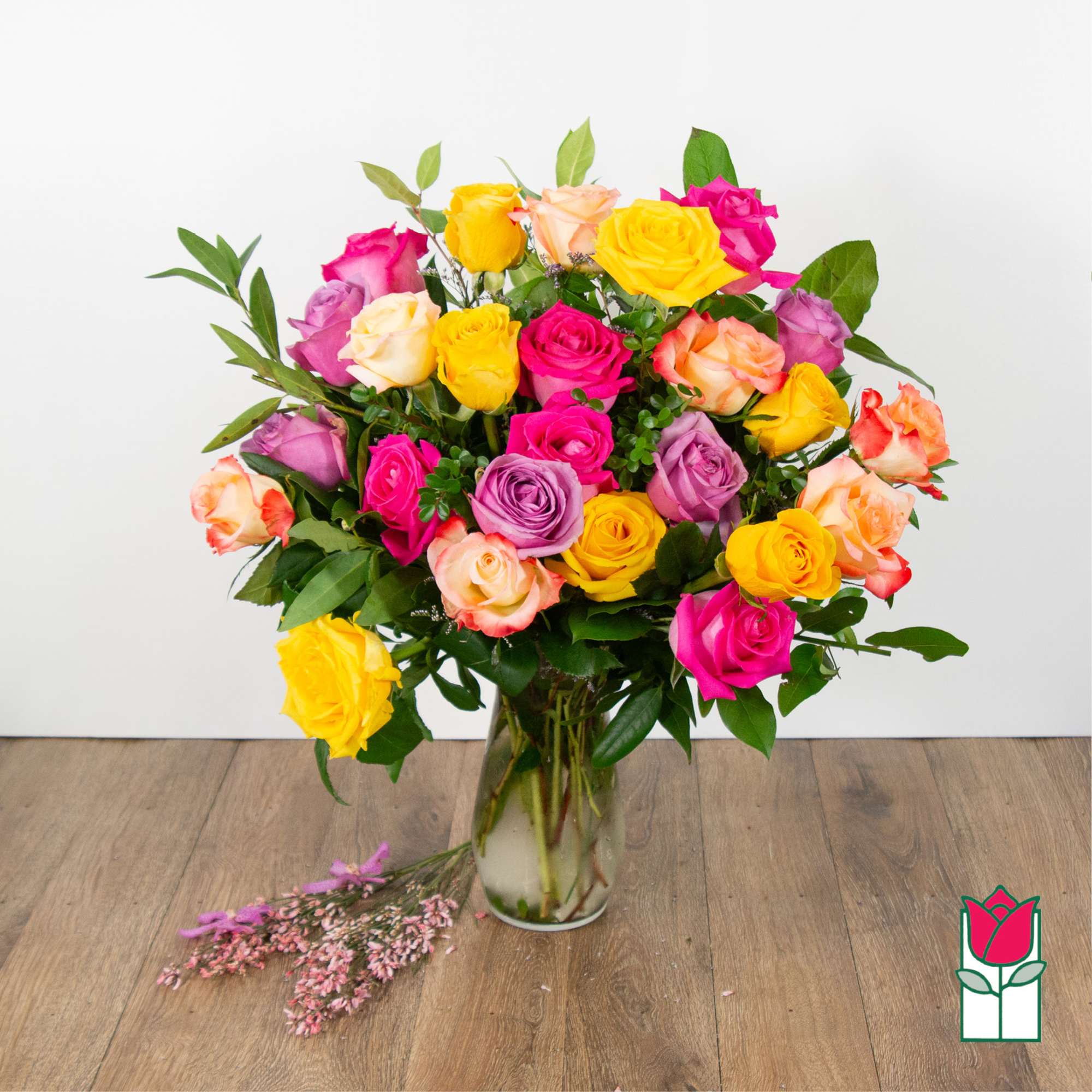 Bouquet of multicolored roses in a clear glass vase