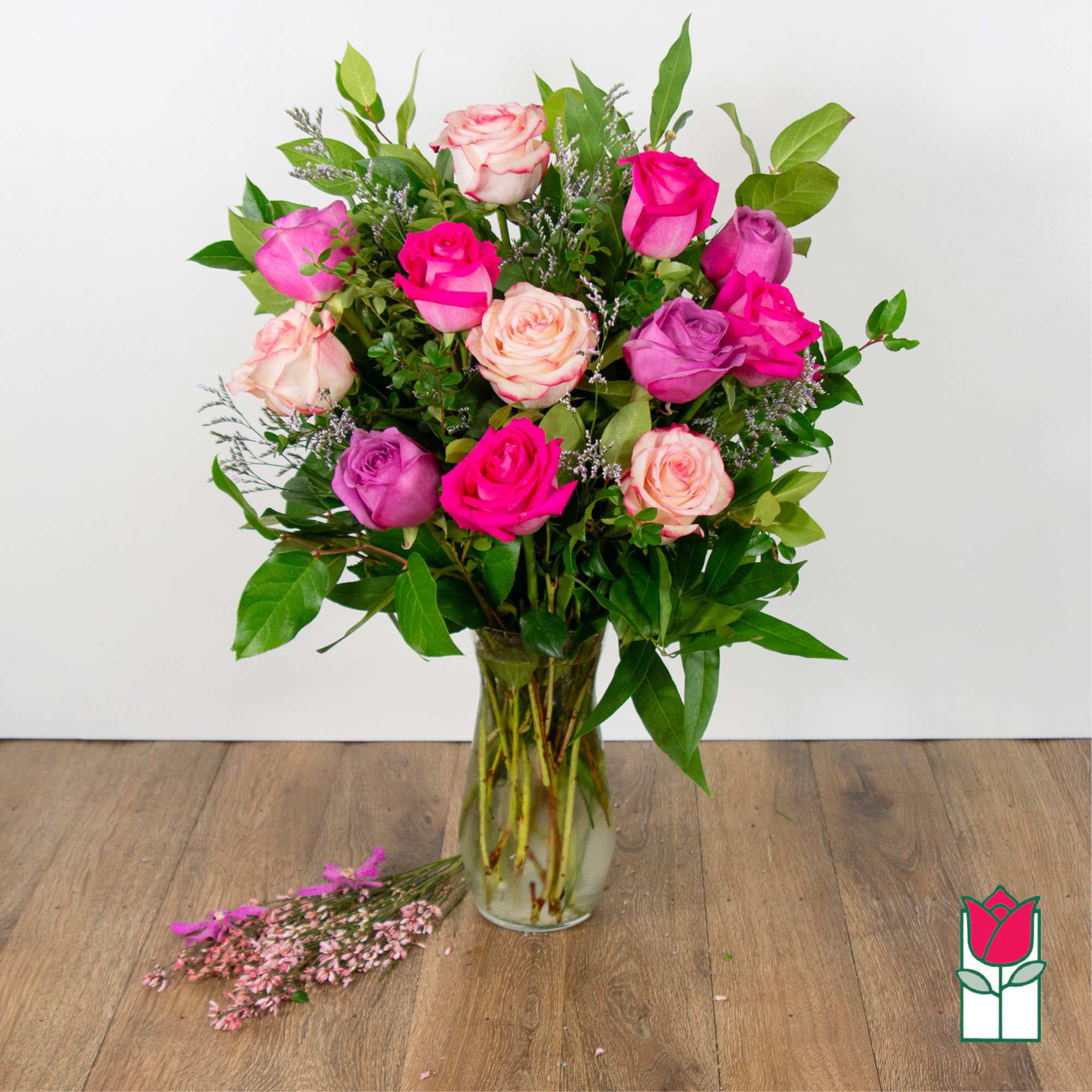 Bouquet of pink and lavender roses in a clear glass vase