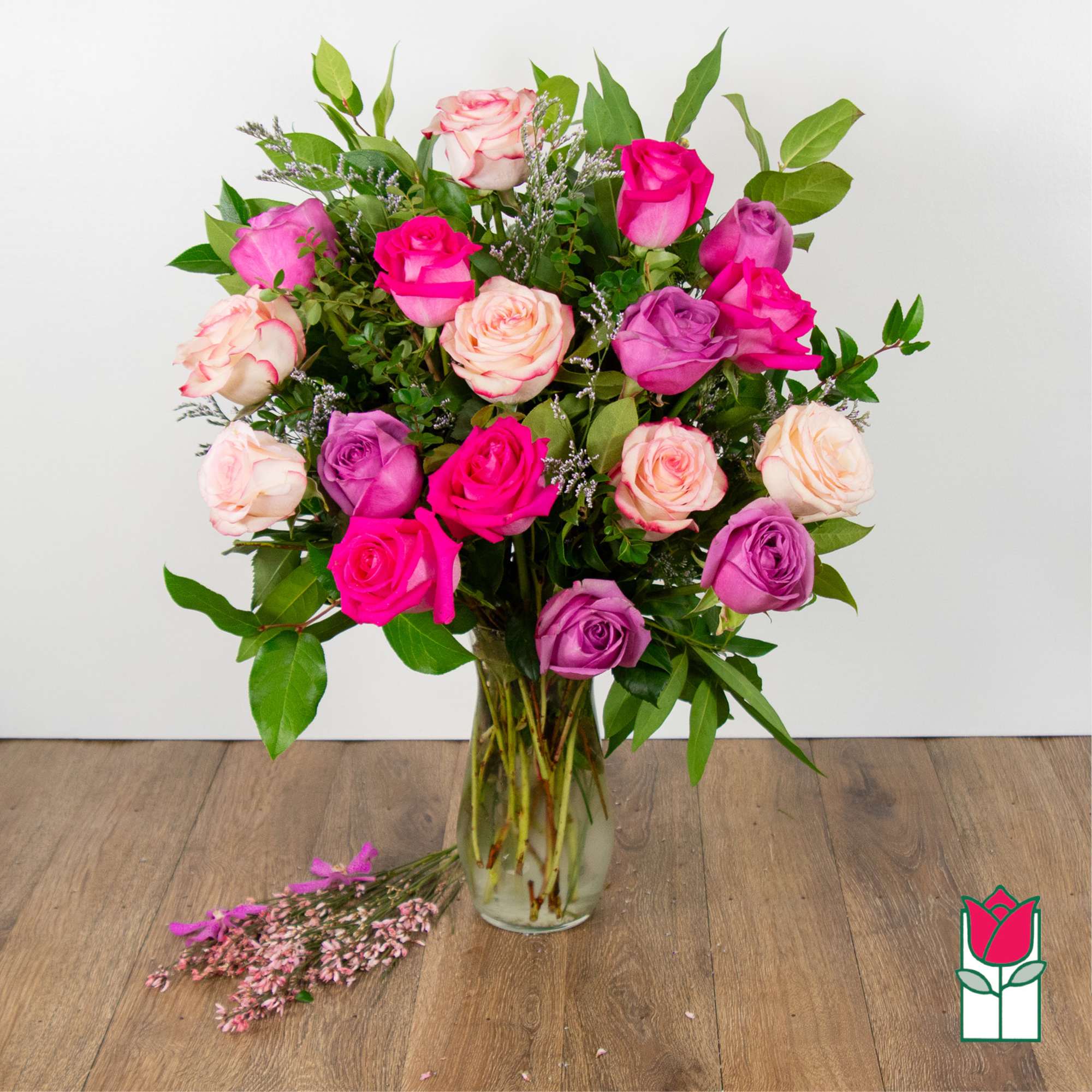 Bouquet of pink and purple roses in a clear glass vase