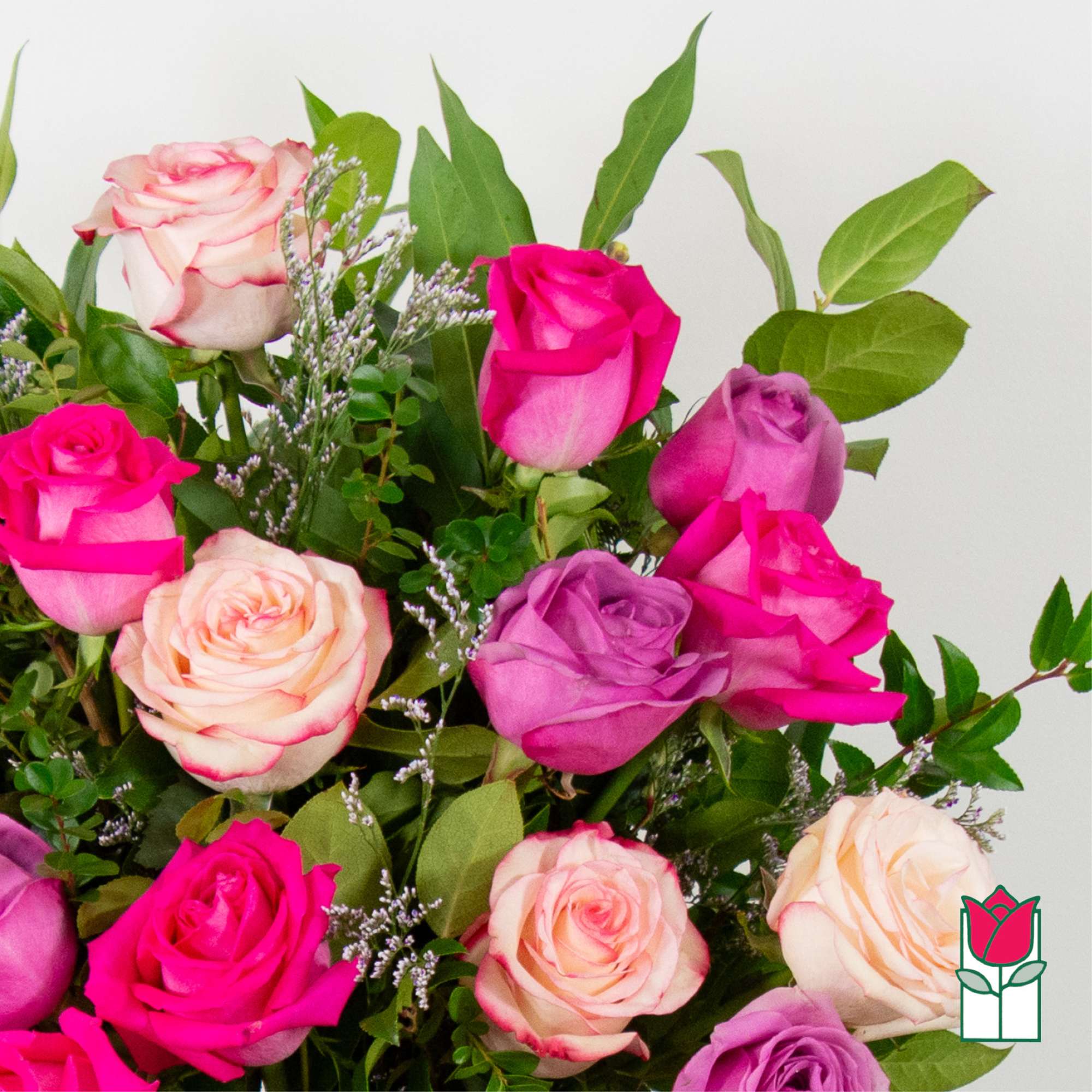Bouquet of pink, lavender, and peach roses with greenery