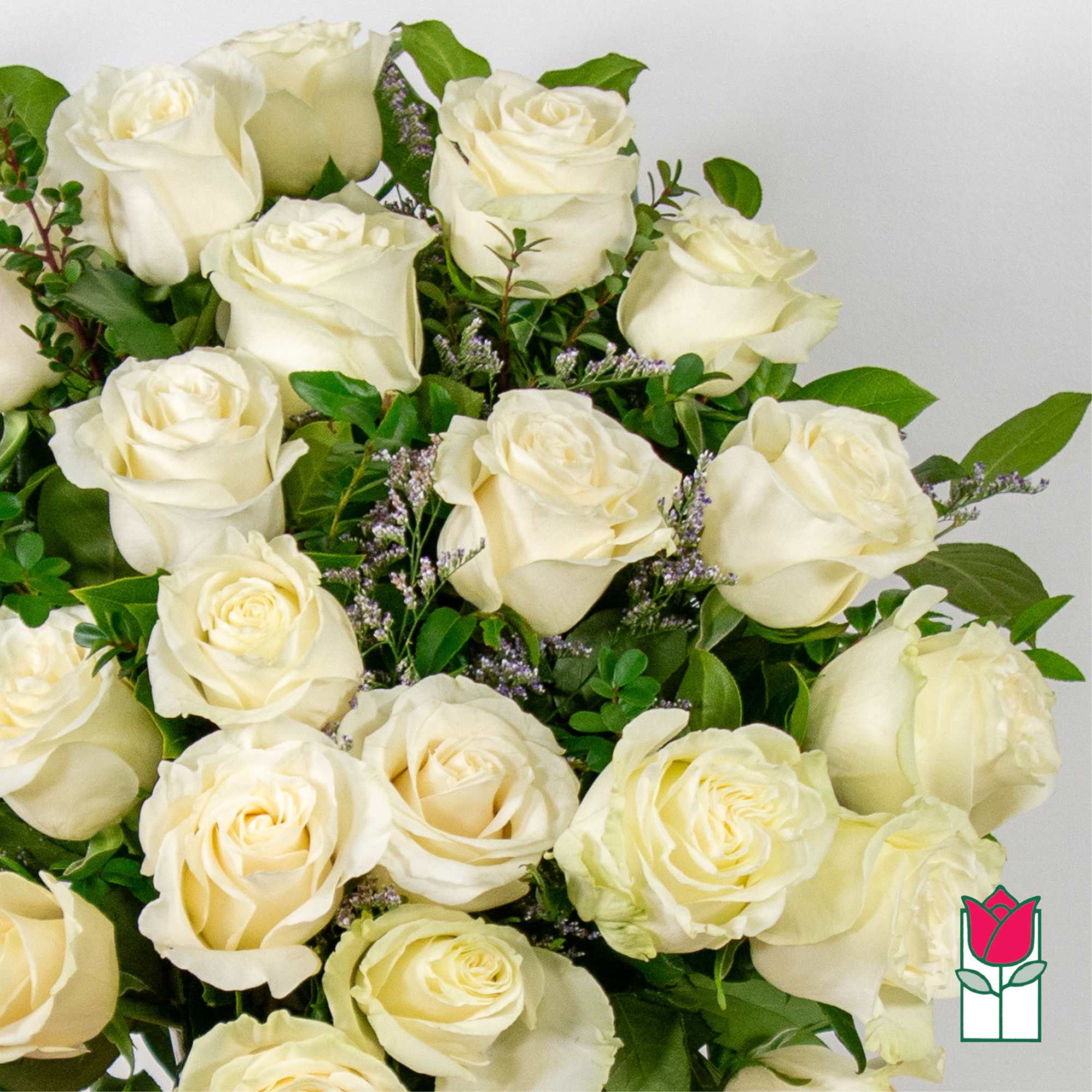 Bouquet of white roses with green foliage and small purple filler flowers