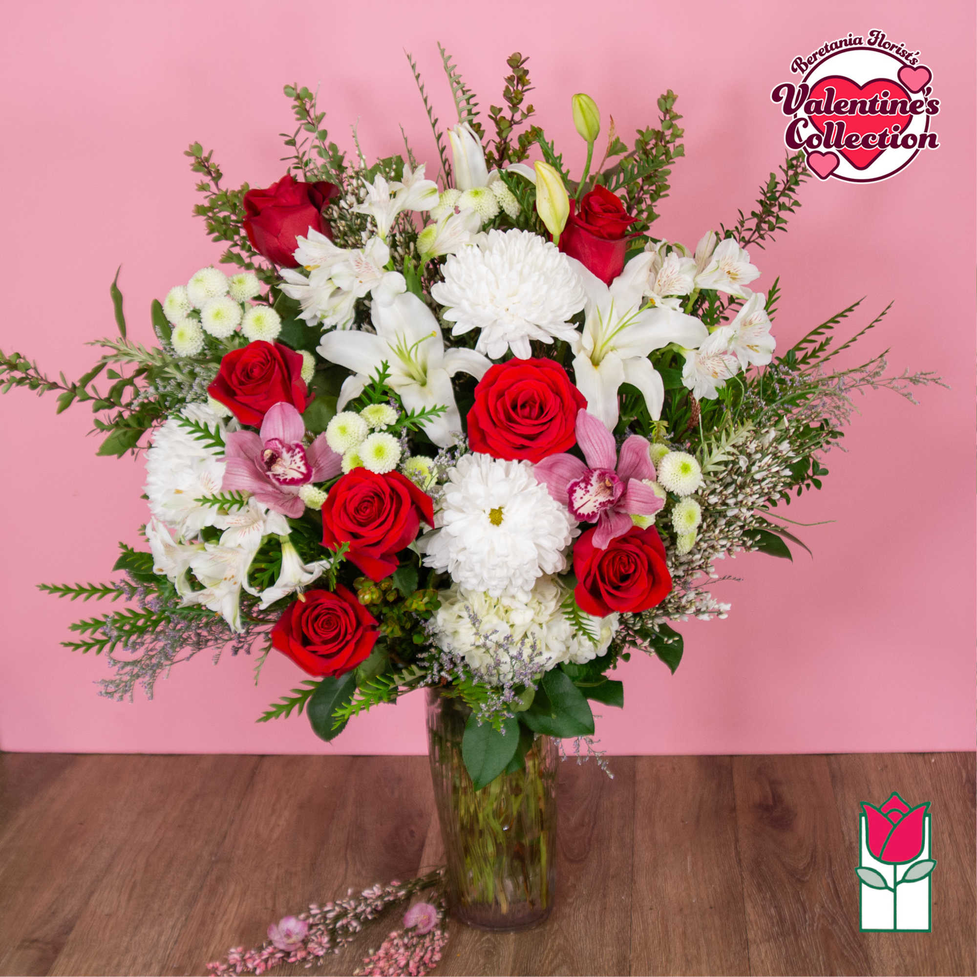 Bouquet of red roses and white lilies in a glass vase