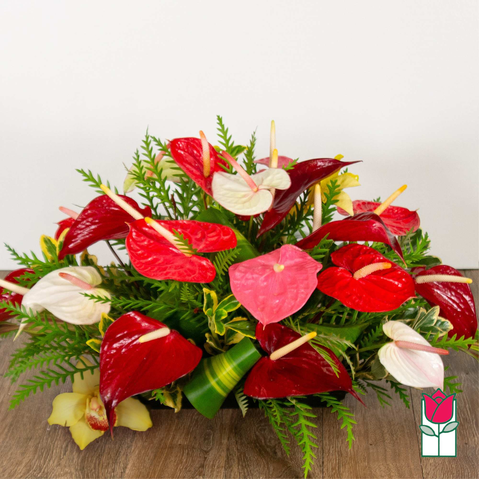 Arrangement of red, white, and pink anthuriums with greenery, photo 2 of 4