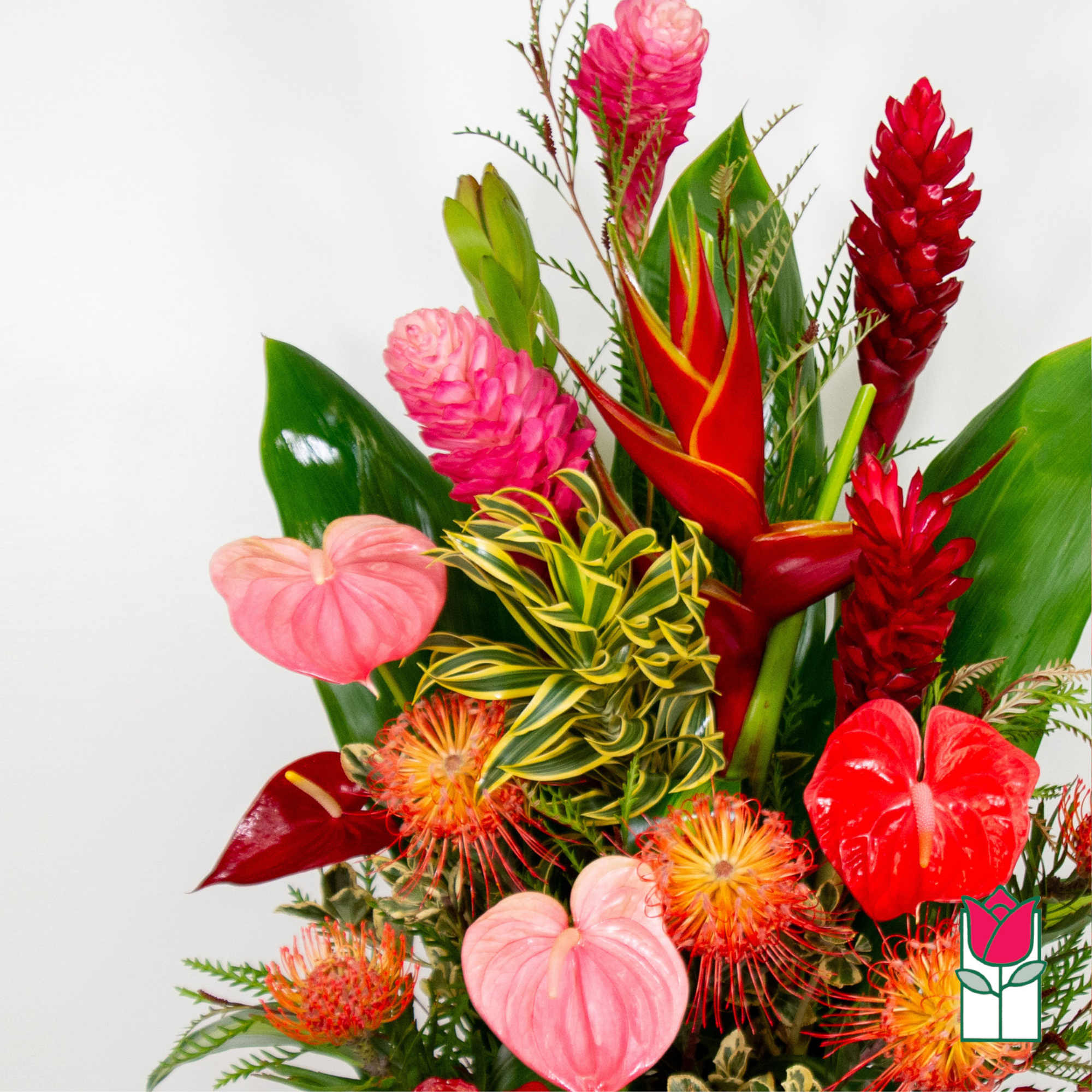 Tropical bouquet with red and pink flowers and glossy green leaves