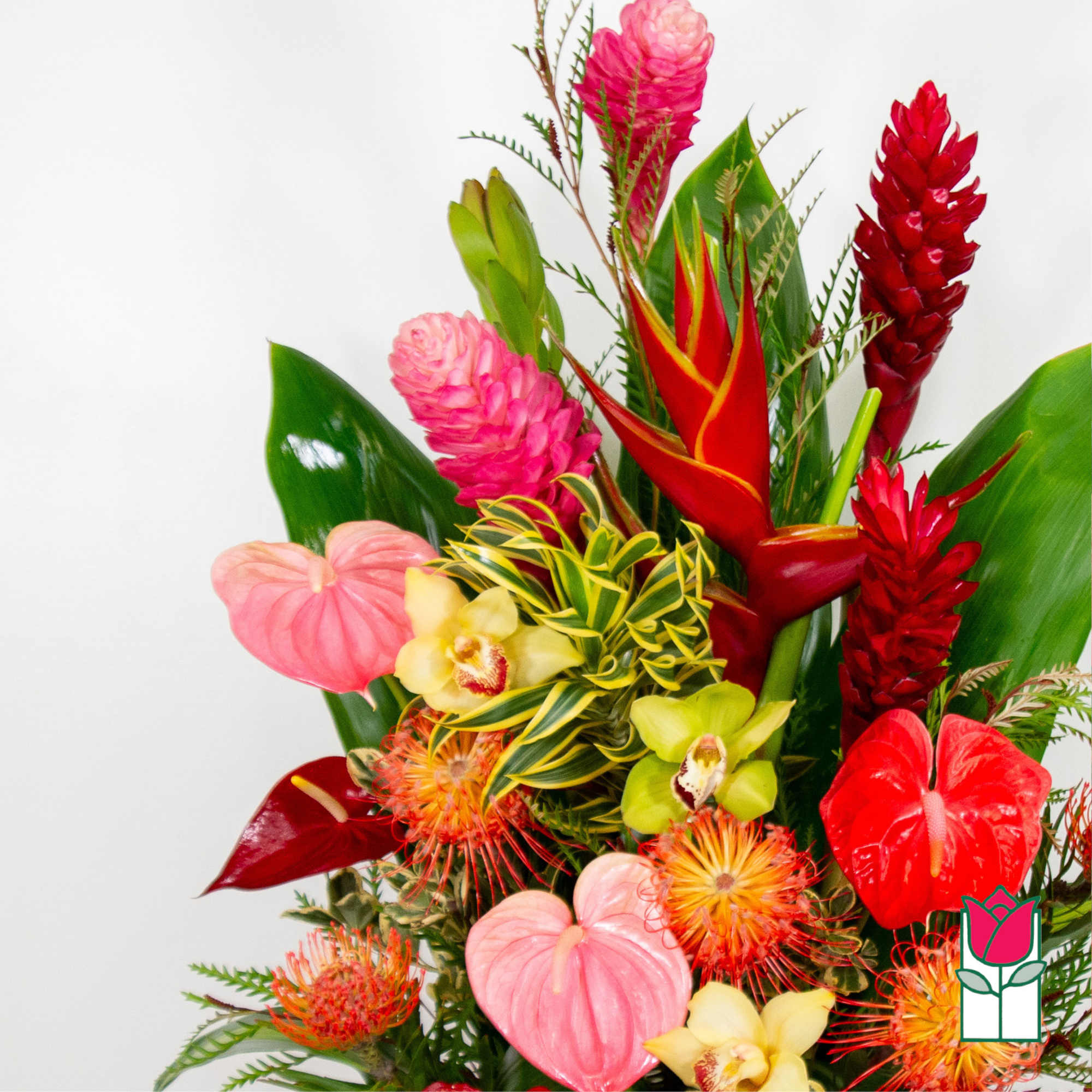 Tropical bouquet with red and pink blooms and green foliage