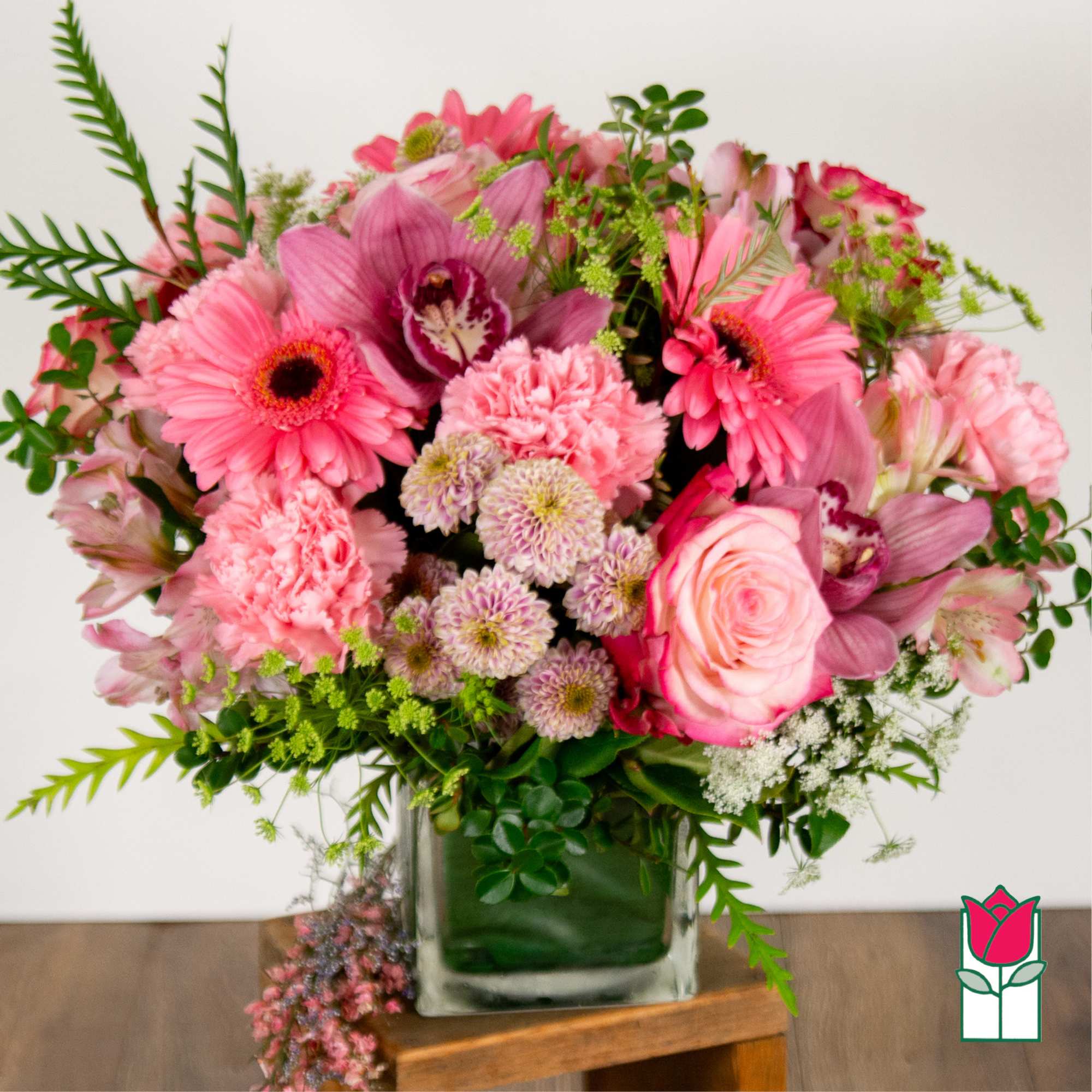 Pink mixed flower arrangement in a glass vase