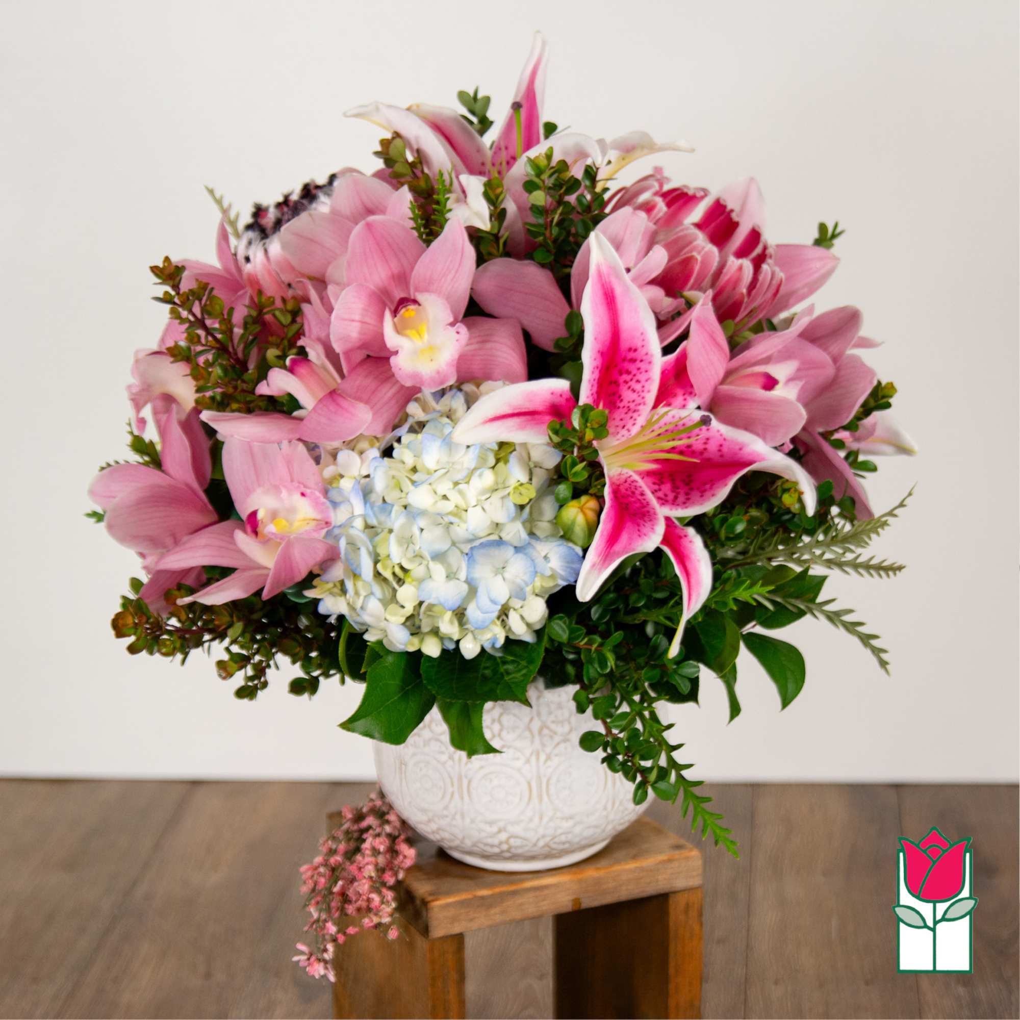 Pink lilies and hydrangea in a white vase